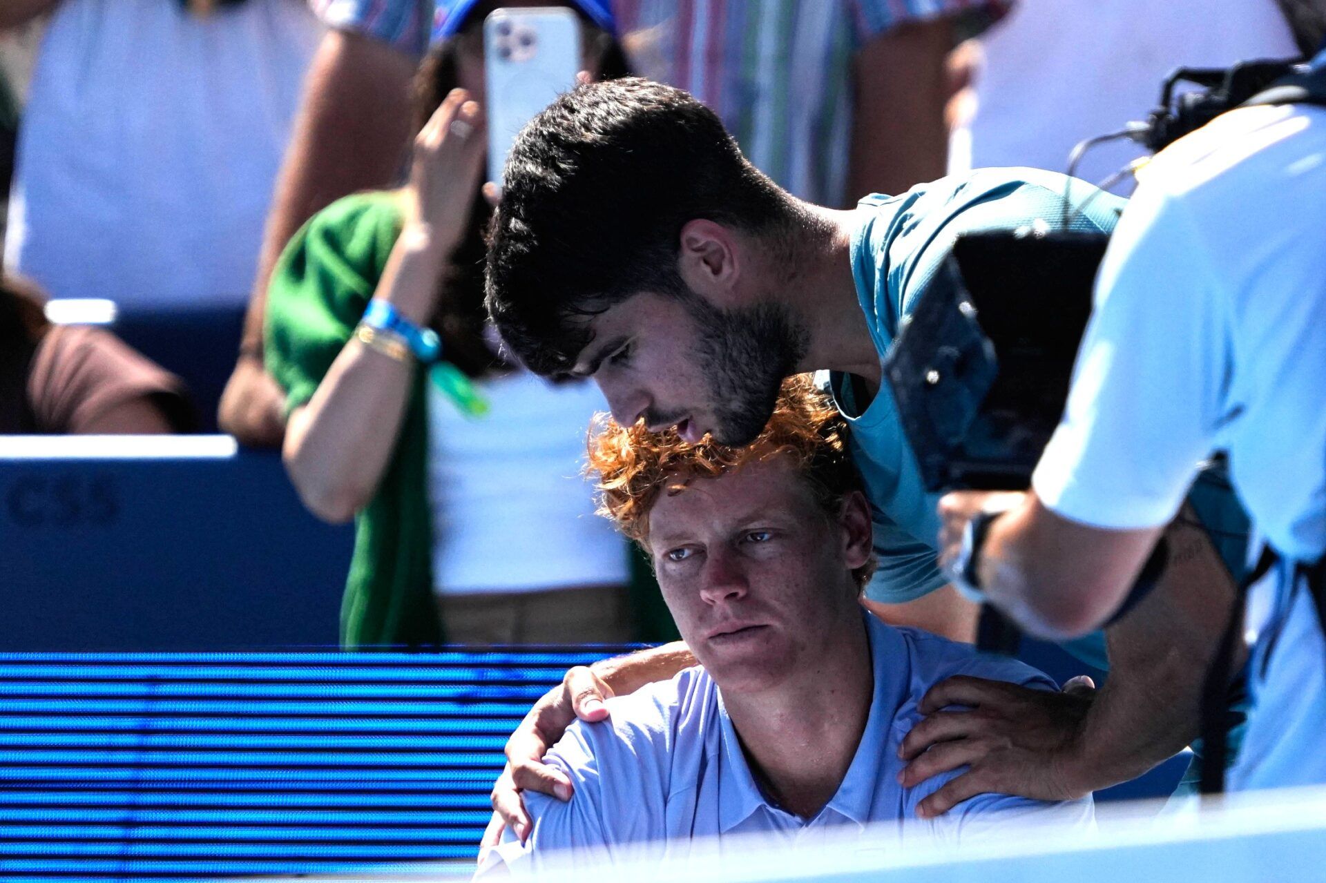 Carlos Alcaraz speaks with Jannik Sinner after Sinner retired due to illness after losing five games from their men's finals match at the Cincinnati Open in Mason, Ohio,on Monday, Aug. 18, 2025.