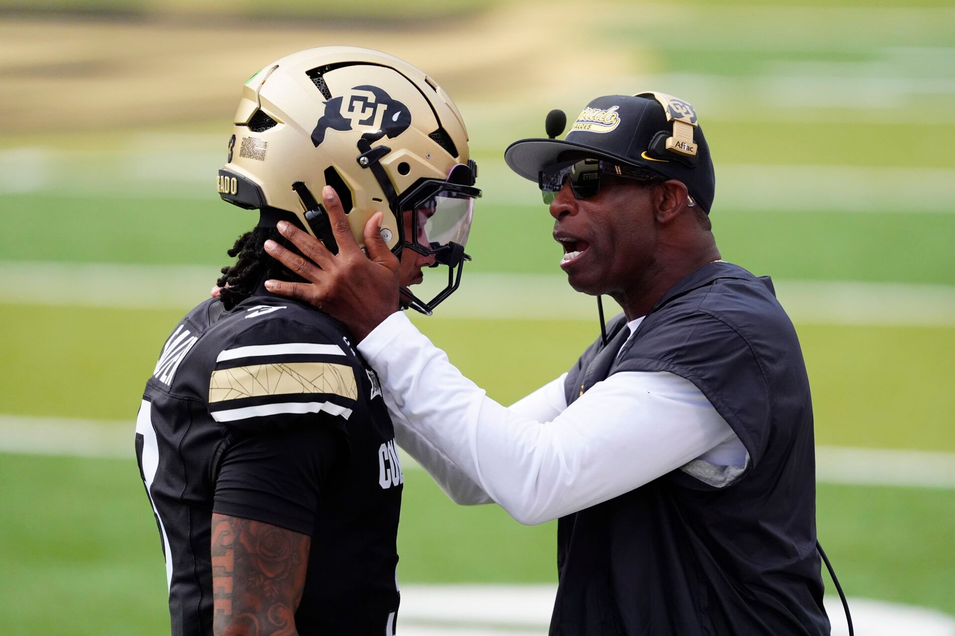 Colorado Buffaloes head coach Deion Sanders congratulates Colorado Buffaloes quarterback Kaidon Salter (3) following a touchdown pass in the first quarter against the Georgia Tech Yellow Jackets at Folsom Field.