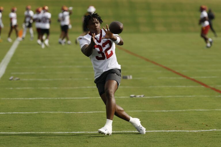 Washington Commanders running back Jacory Croskey-Merritt (32) catches a ball during practice on day one of training camp at OrthoVirginia Training Center at Commanders Park.