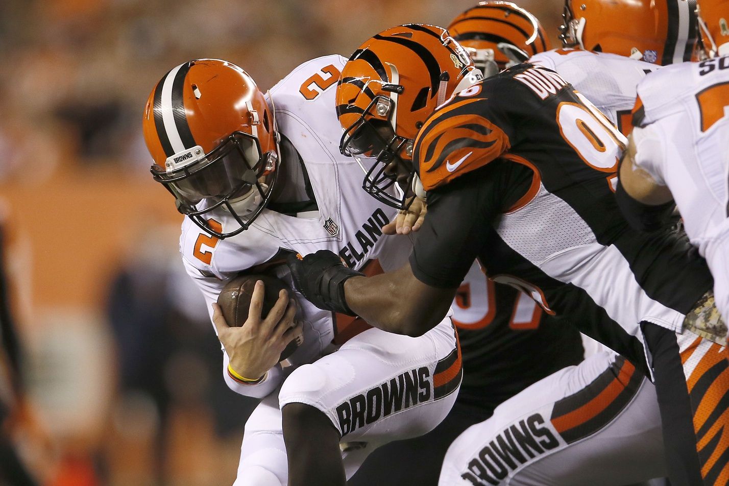 Cincinnati Bengals defensive end Carlos Dunlap (96), right, sacks Cleveland Browns quarterback Johnny Manziel (2) in the fourth quarter during the Week 9 NFL football game between the Cleveland Browns and Cincinnati Bengals, Thursday, Nov. 5, 2015, at Paul Brown Stadium in Cincinnati.

110515 Browns Bengals