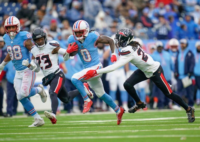 Tennessee Titans wide receiver Calvin Ridley (0) is tackled by Houston Texans safety Calen Bullock (21) after a first down during the second quarter at Nissan Stadium in Nashville, Tenn., Sunday, Jan. 5, 2025.