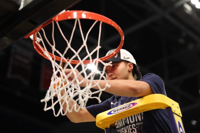Connecticut Huskies guard Azzi Fudd (35) cuts off a piece of the net after the national championship of the women's 2025 NCAA tournament against the South Carolina Gamecocks at Amalie Arena.