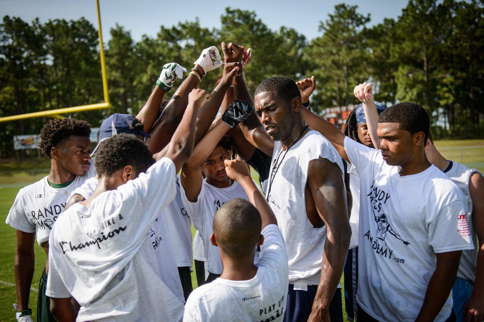 Former NFL player Randy Moss brings it in with a group of young athletes Saturday, July 11, 2015, during a football clinic at South View High School.