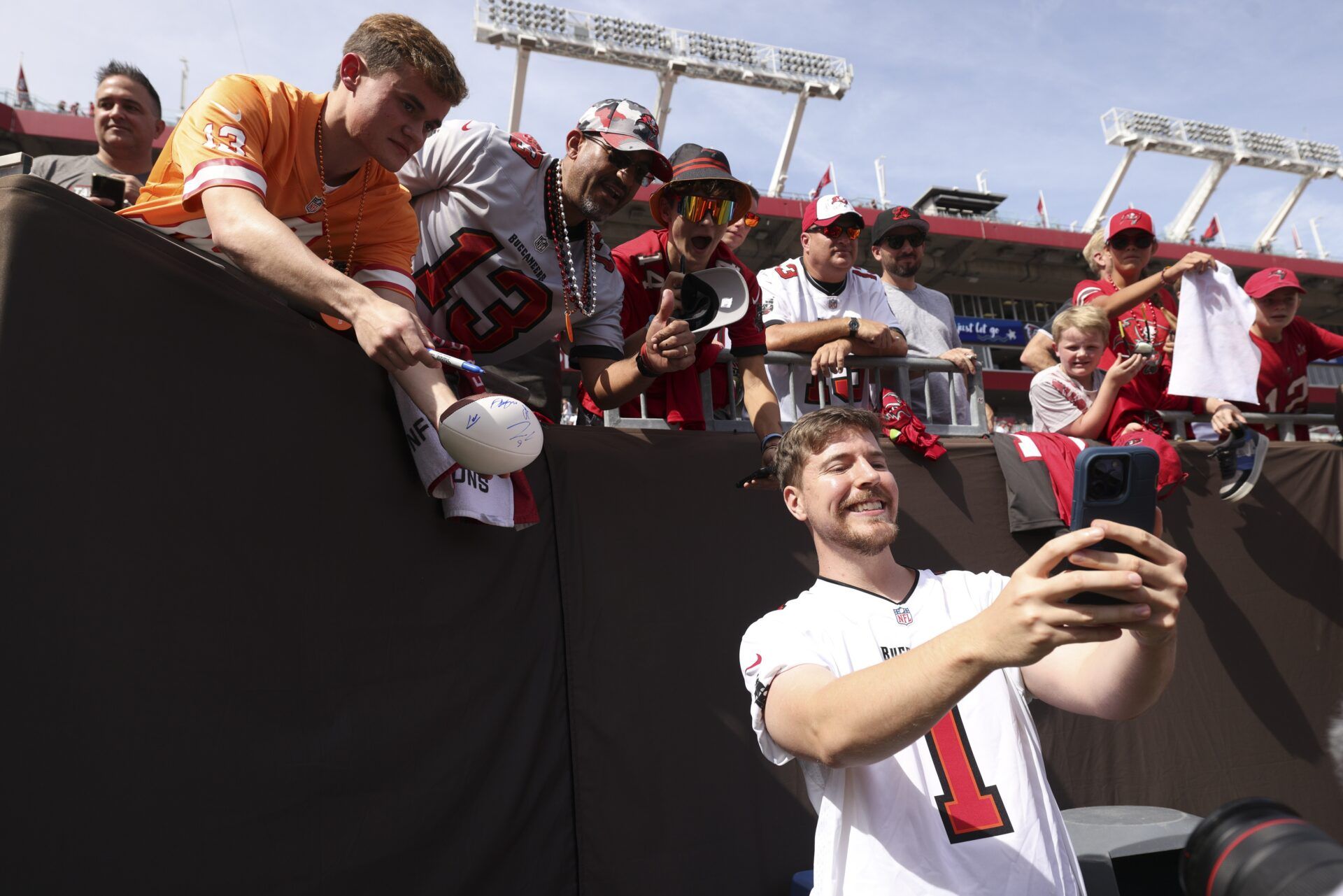 YouTuber Jimmy Donaldson MrBeast takes photos with fans before a game between the Atlanta Falcons and Tampa Bay Buccaneers at Raymond James Stadium.