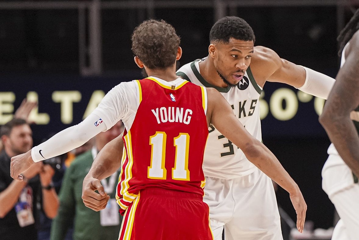 Milwaukee Bucks forward Giannis Antetokounmpo (34) reacts with Atlanta Hawks guard Trae Young (11) after the Bucks defeated the Hawks at State Farm Arena.
