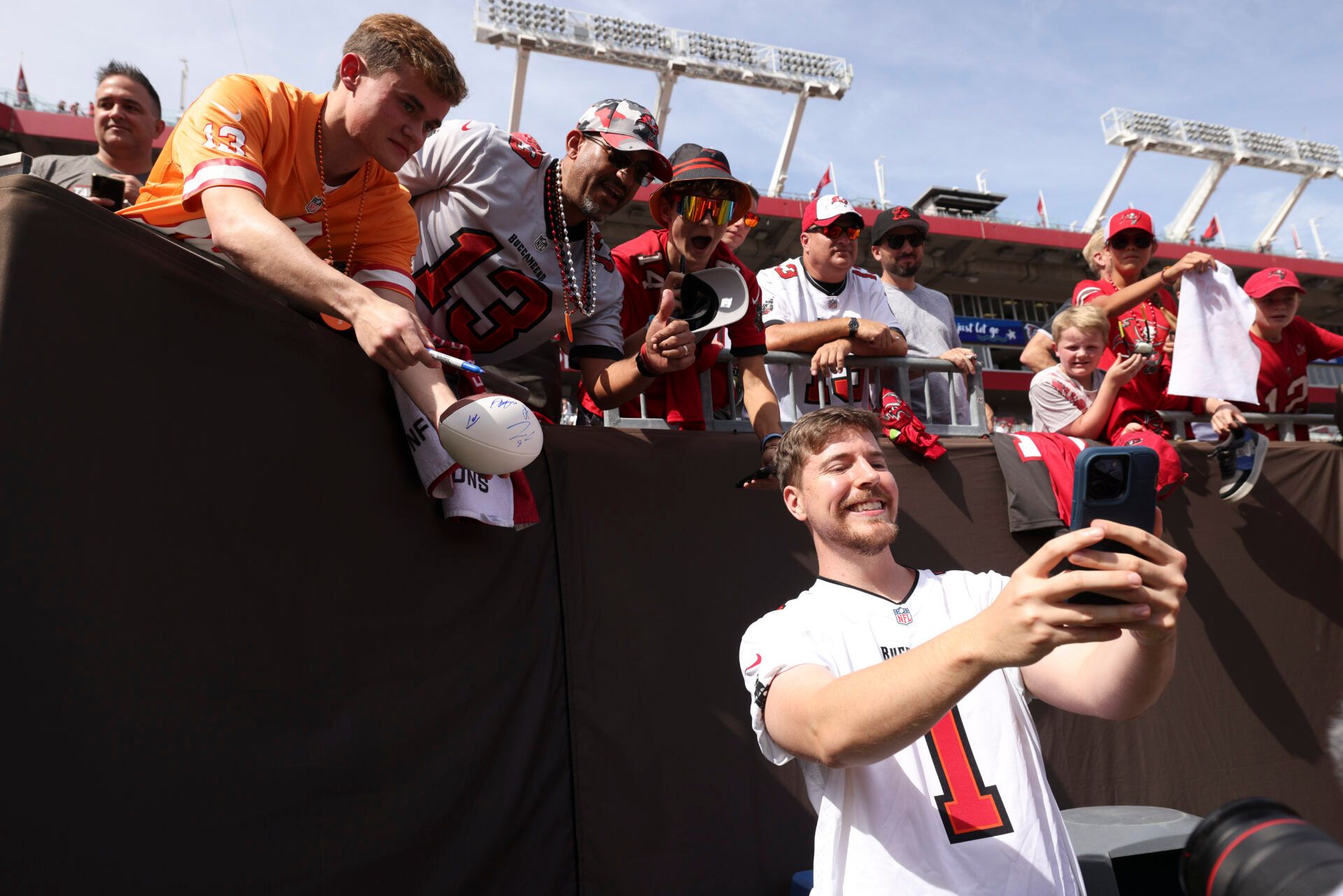YouTuber Jimmy Donaldson MrBeast takes photos with fans before a game between the Atlanta Falcons and Tampa Bay Buccaneers at Raymond James Stadium.