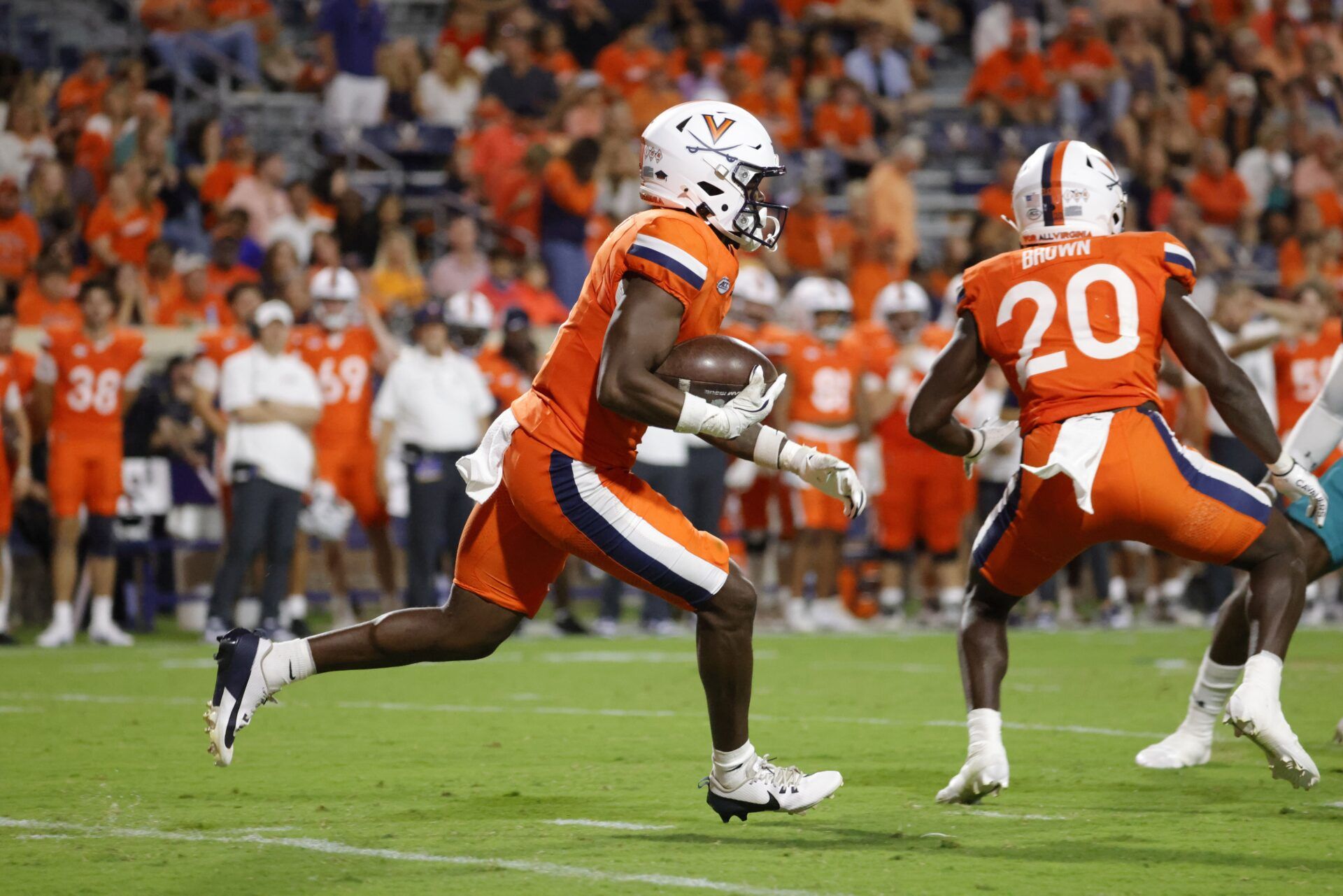 Virginia Cavaliers wide receiver Cam Ross (6) carries the ball to score a touchdown against the Coastal Carolina Chanticleers during the second half at Scott Stadium.