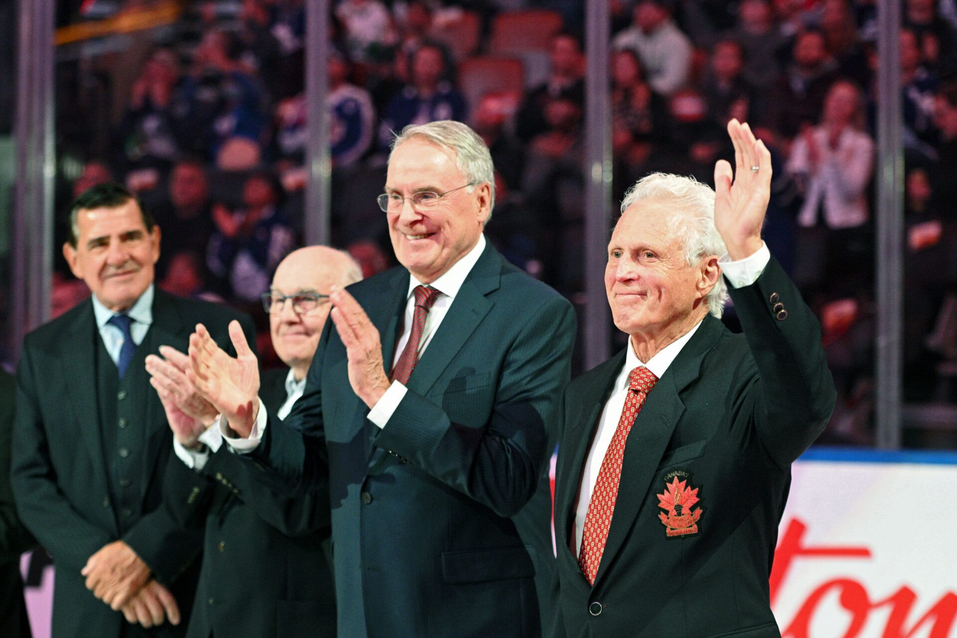 (EDITORS NOTE: caption correction) Sep 28, 2022; Toronto, Ontario, CAN; Former NHL and Team Canada player Paul Henderson waves as he is applauded by team mates (from right) Ken Dryden, Ron Ellis and Serge Savard during a ceremony to honor members of the team that played in the 1972 Summit Series against the Soviet Union before the start of the Montreal Canadiens at Toronto Maple Leafs game at Scotiabank Arena.