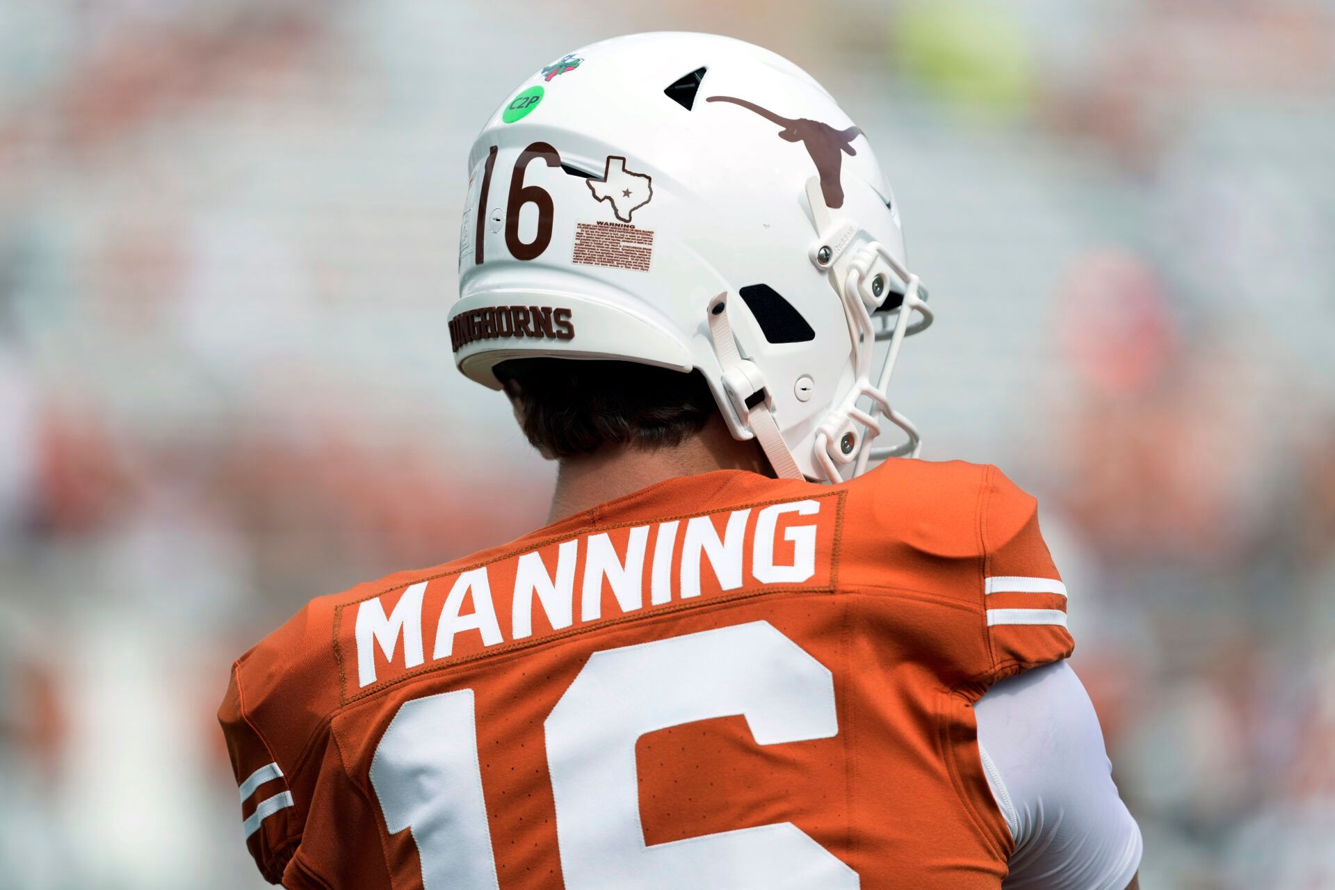 Texas Longhorns quarterback Arch Manning (16) and teammates wear Texas sticker on their helmets with a star honoring Texas flood victims during the game against San Jose State Spartans at Darrell K Royal-Texas Memorial Stadium.