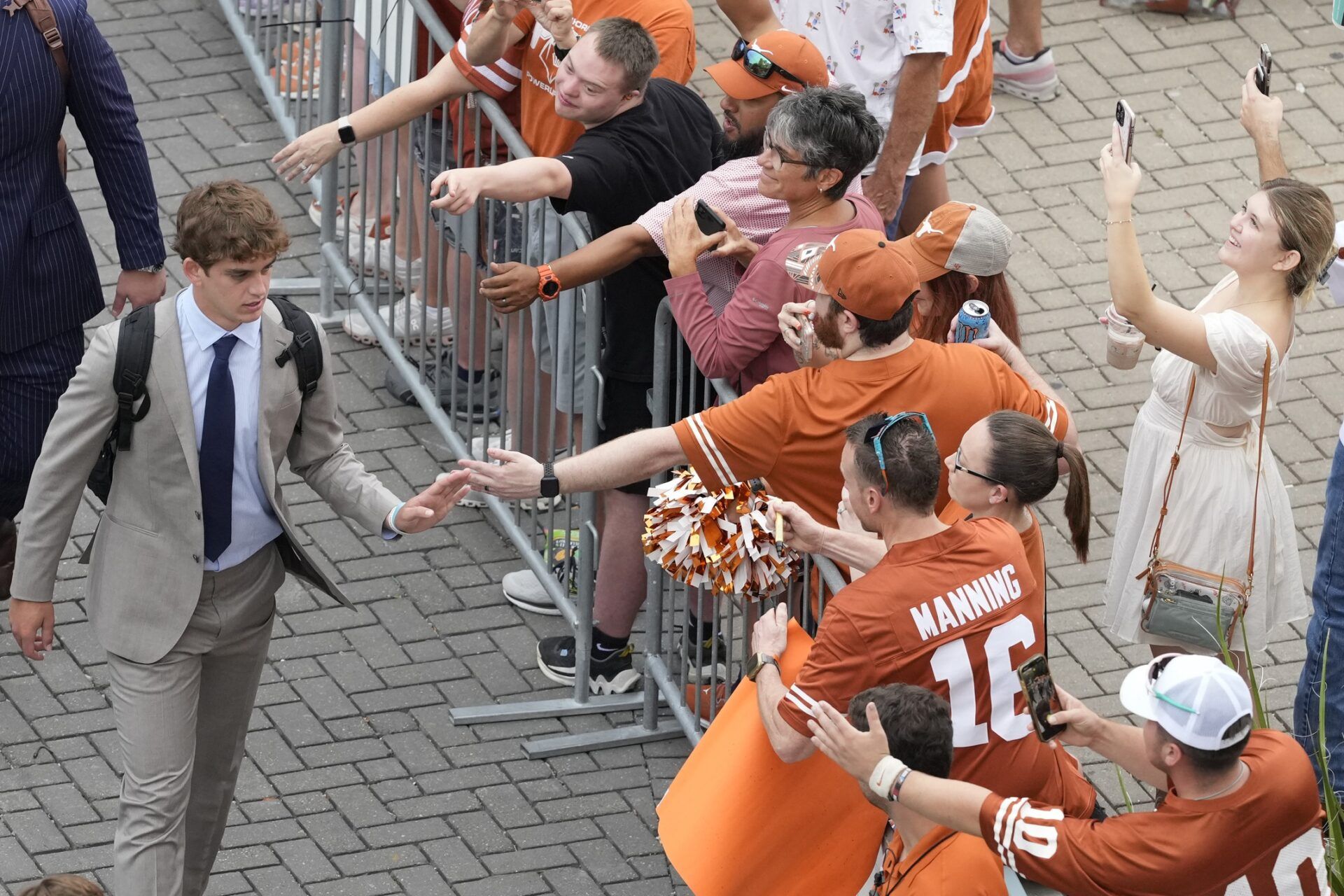Texas Longhorns quarterback Arch Manning (16) greets fans upon entering Darrell K Royal-Texas Memorial Stadium before a game against the San Jose Spartans.