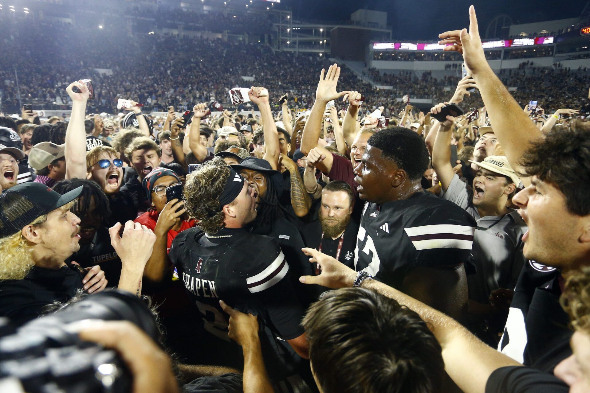 Mississippi State Bulldogs fans crowd around quarterback Blake Shapen (2) and offensive lineman Zack Owens (52) after defeating the Arizona State Sun Devilsat Davis Wade Stadium at Scott Field.