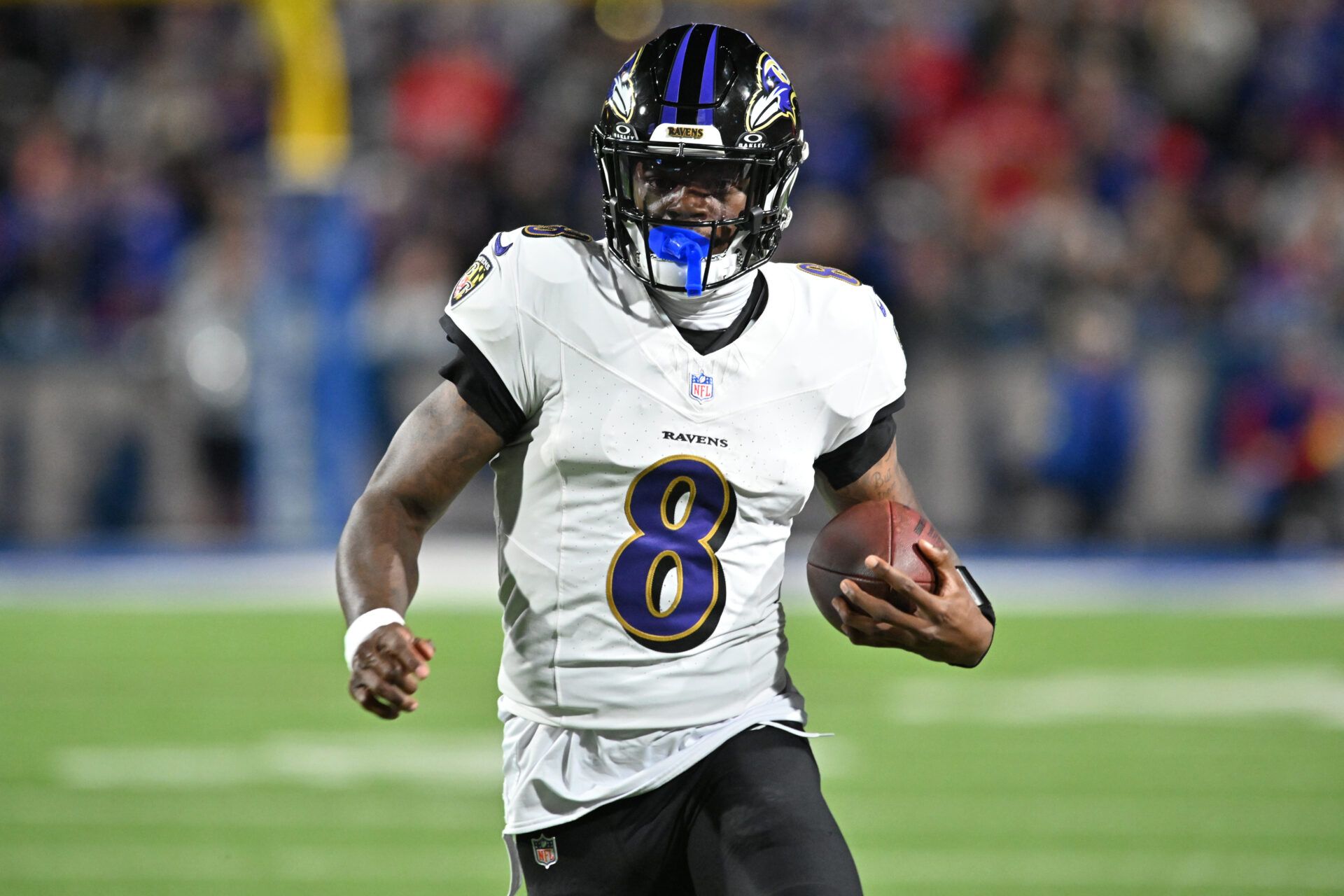 Baltimore Ravens quarterback Lamar Jackson (8) runs with the ball against the Buffalo Bills during the second quarter at Highmark Stadium.