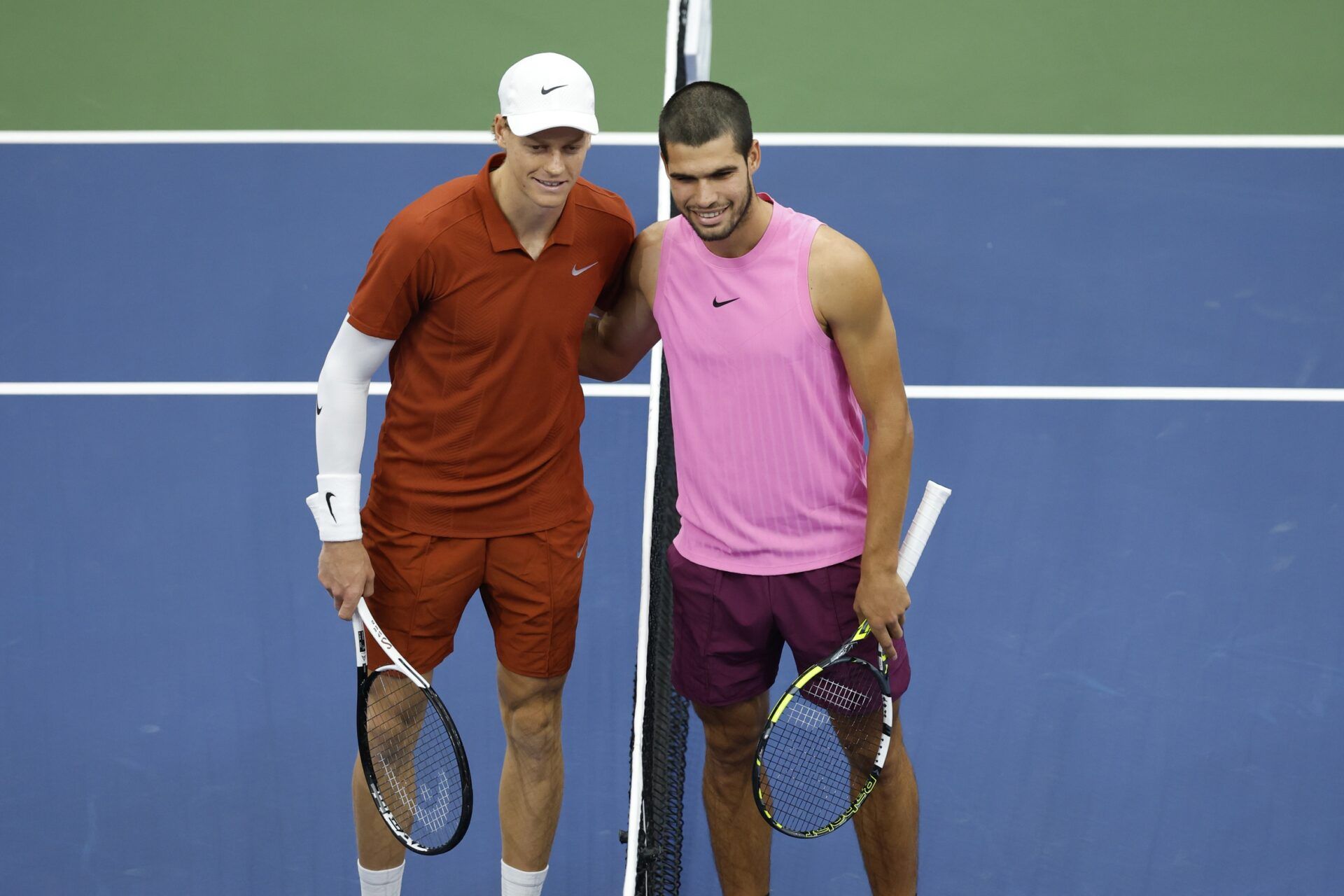 Jannik Sinner (ITA) and Carlos Alcaraz (ESP) pose for a photo at the net prior to the final of mens singles at Billie Jean King National Tennis Center.