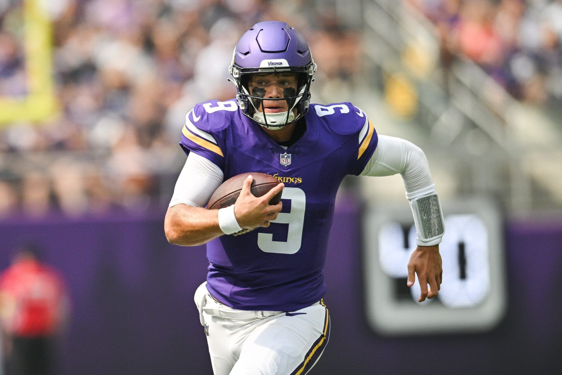 Minnesota Vikings quarterback J.J. McCarthy (9) scrambles for a gain against the Houston Texans during the first quarter at U.S. Bank Stadium.