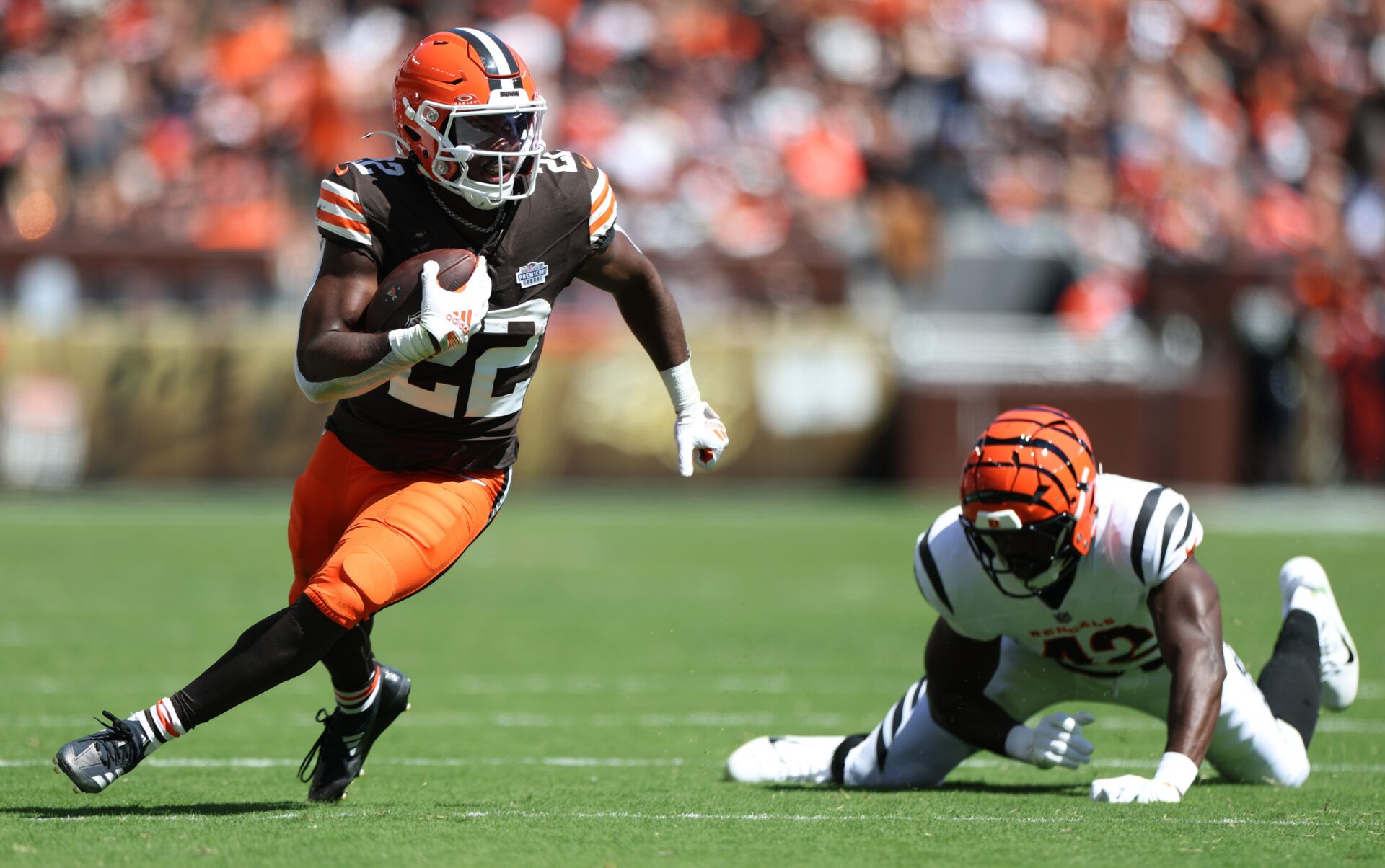 Cleveland Browns running back Dylan Sampson (22) runs against Cincinnati Bengals linebacker Oren Burks (42) during the first half at Huntington Bank Field.