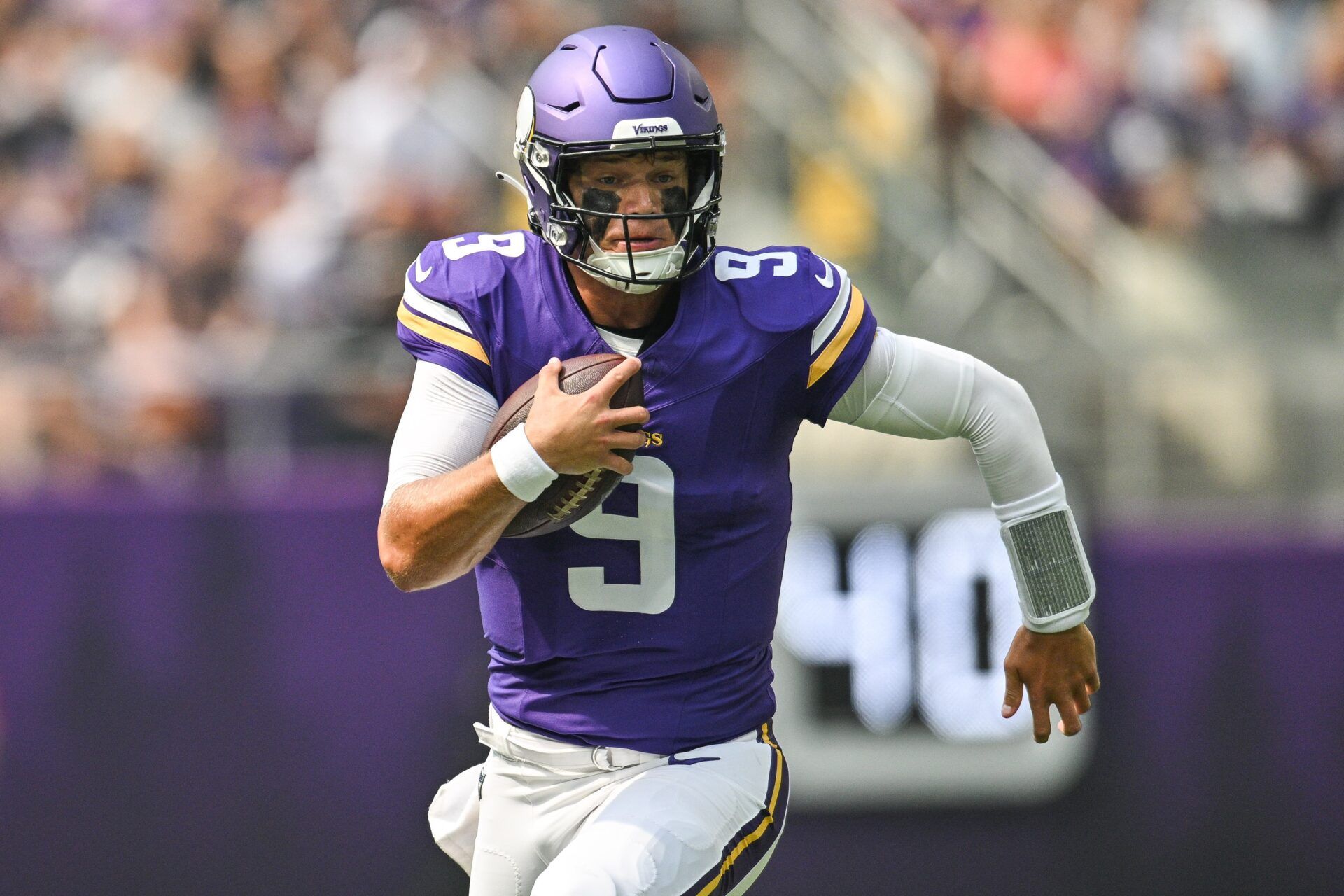 Minnesota Vikings quarterback J.J. McCarthy (9) scrambles for a gain against the Houston Texans during the first quarter at U.S. Bank Stadium.