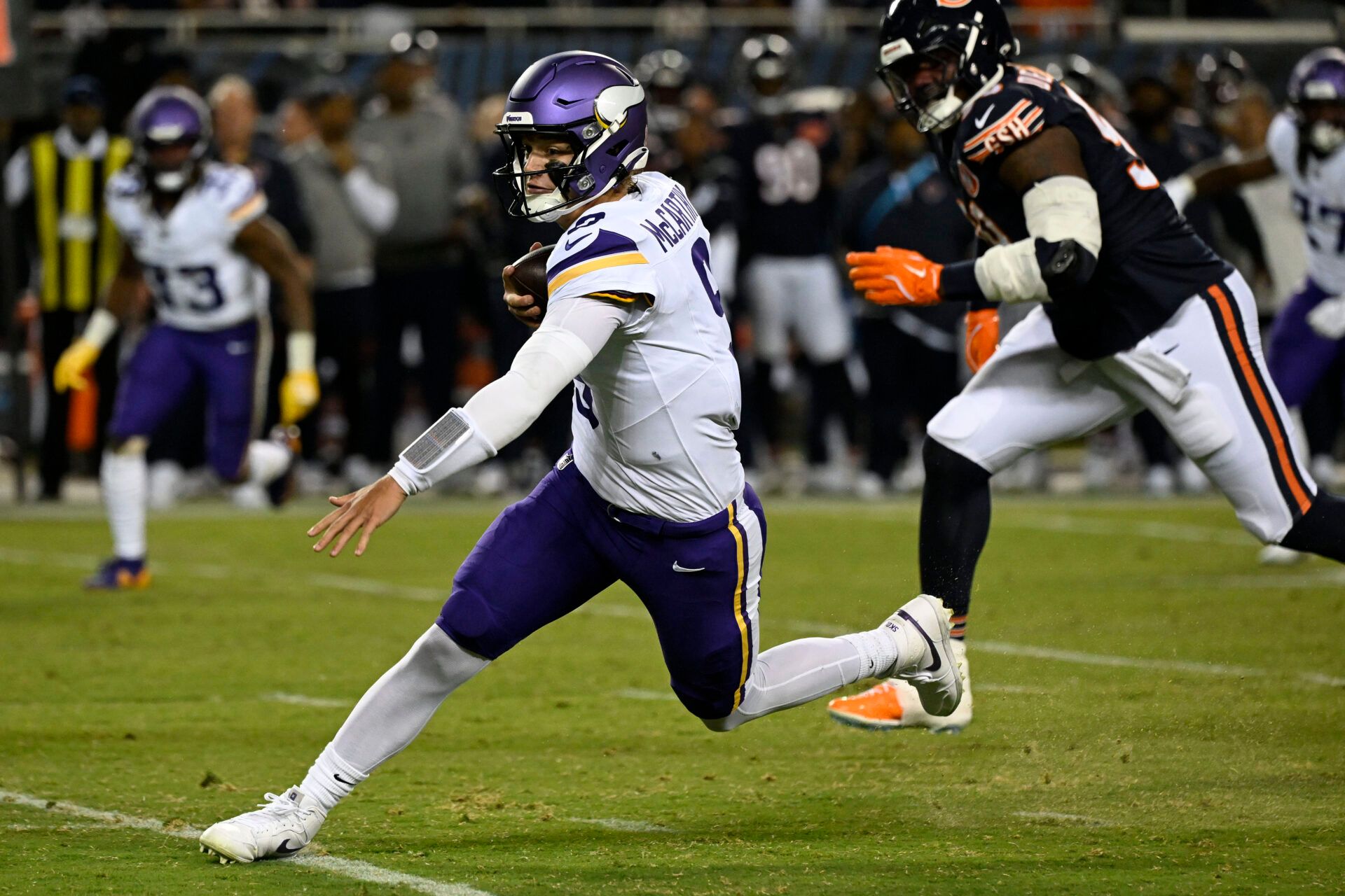 Minnesota Vikings quarterback J.J. McCarthy (9) rushes the ball against the Chicago Bears during the first half at Soldier Field.