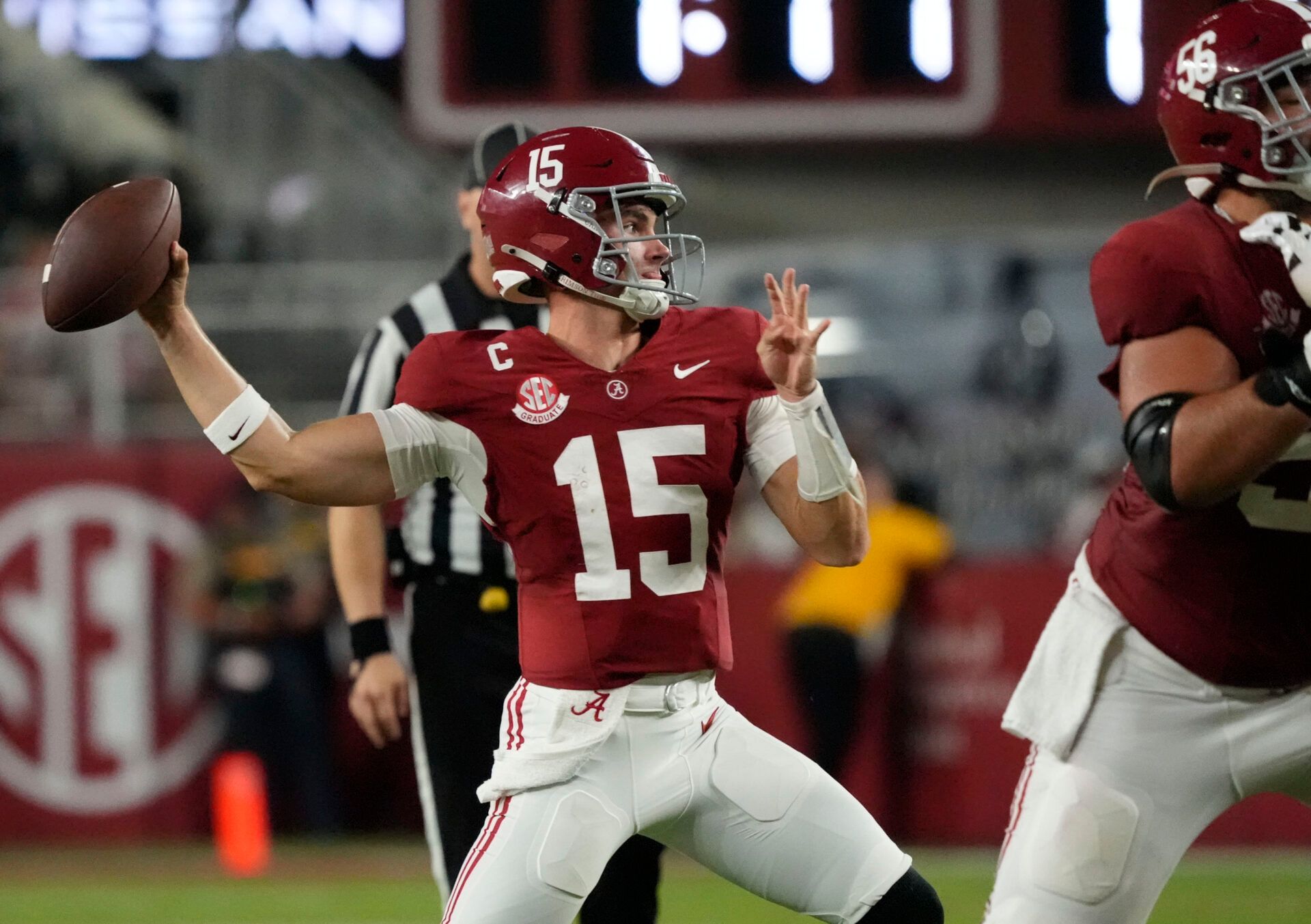 Alabama quarterback Ty Simpson (15) throws against UL Monroe behind a block by Alabama offensive lineman Geno VanDeMark (56) at Saban Field at Bryant-Denny Stadium.