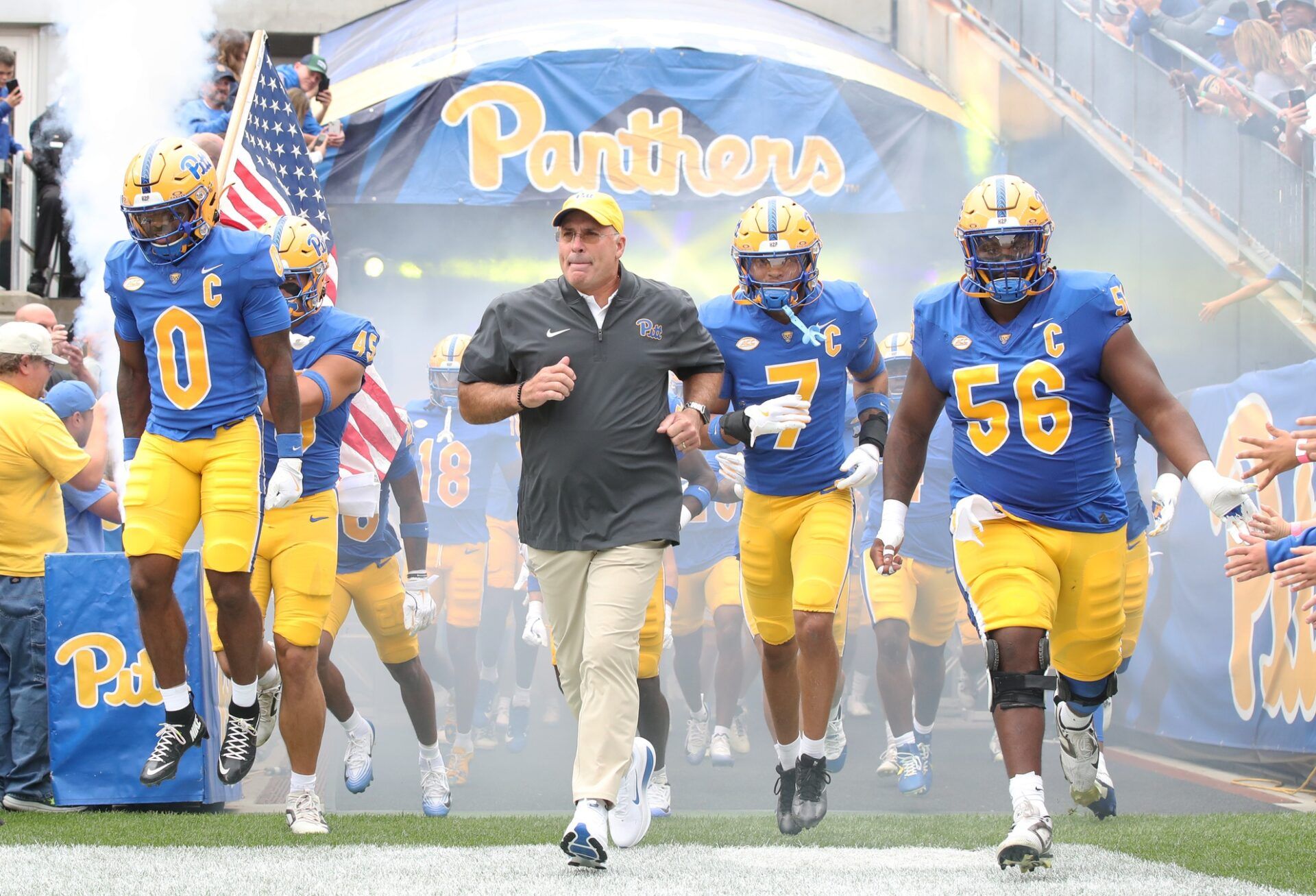 Pittsburgh Panthers running back Desmond Reid (0), head coach Pat Narduzzi, defensive back Javon McIntyre (7) and offensive lineman Lyndon Cooper (56) lead the Panthers onto the field to play the Central Michigan Chippewas  at Acrisure Stadium.