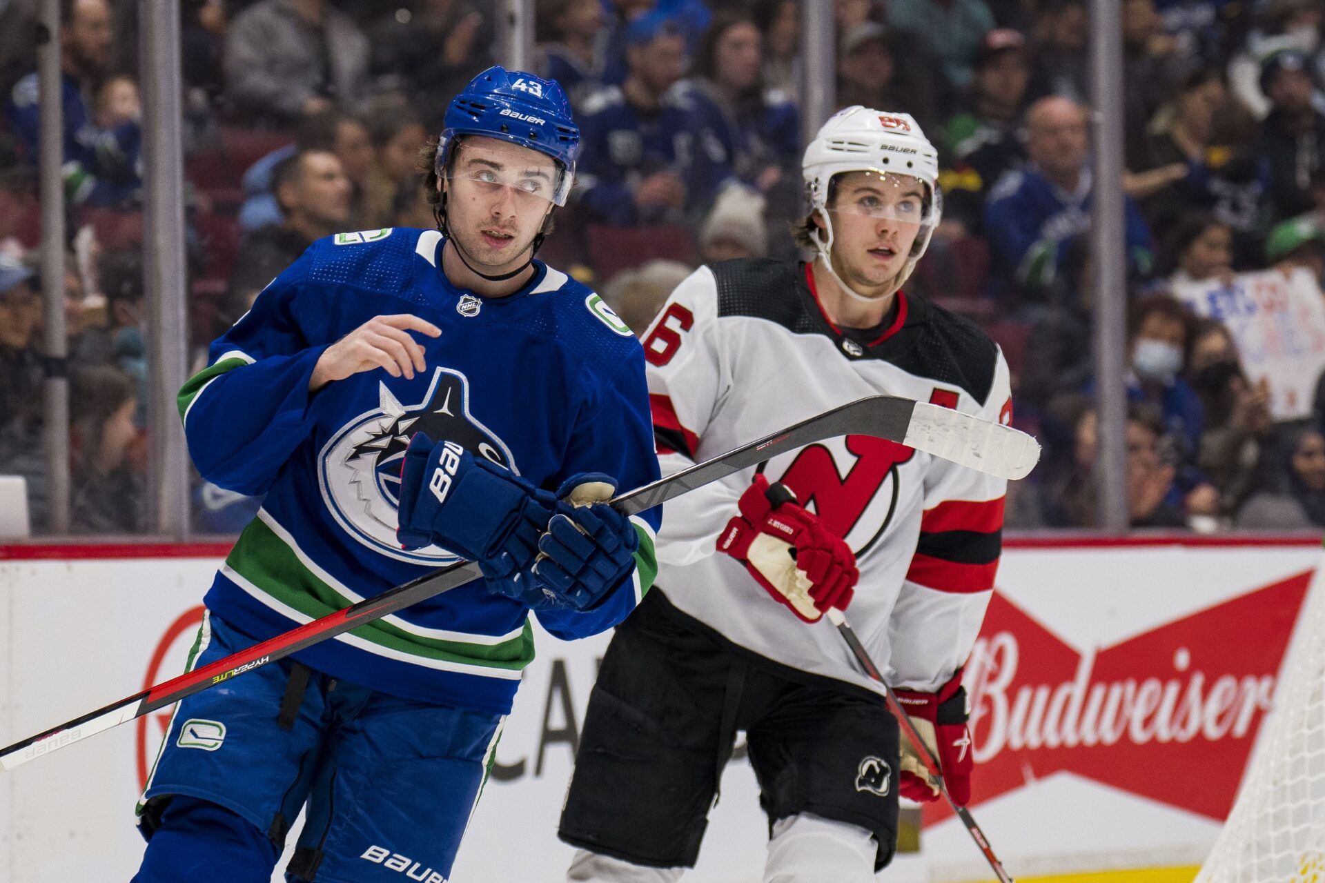Vancouver Canucks defenseman Quinn Hughes (43) shares laugh with his brother New Jersey Devils forward Jack Hughes (86) in the second period at Rogers Arena.
