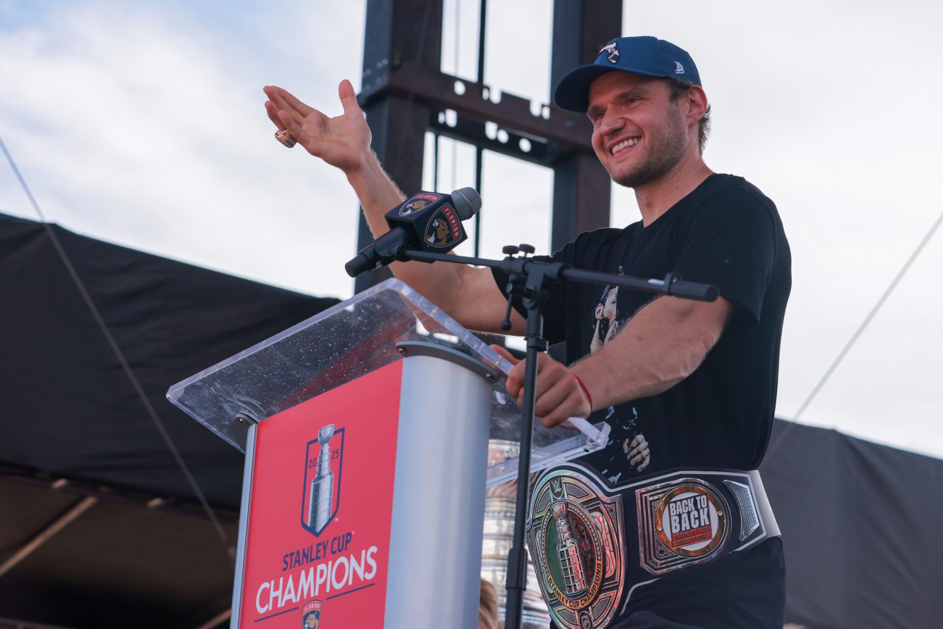 Florida Panthers center Aleksander Barkov (16) speaks to the fans while wearing a championship belt during the Stanley Cup championship parade and rally.