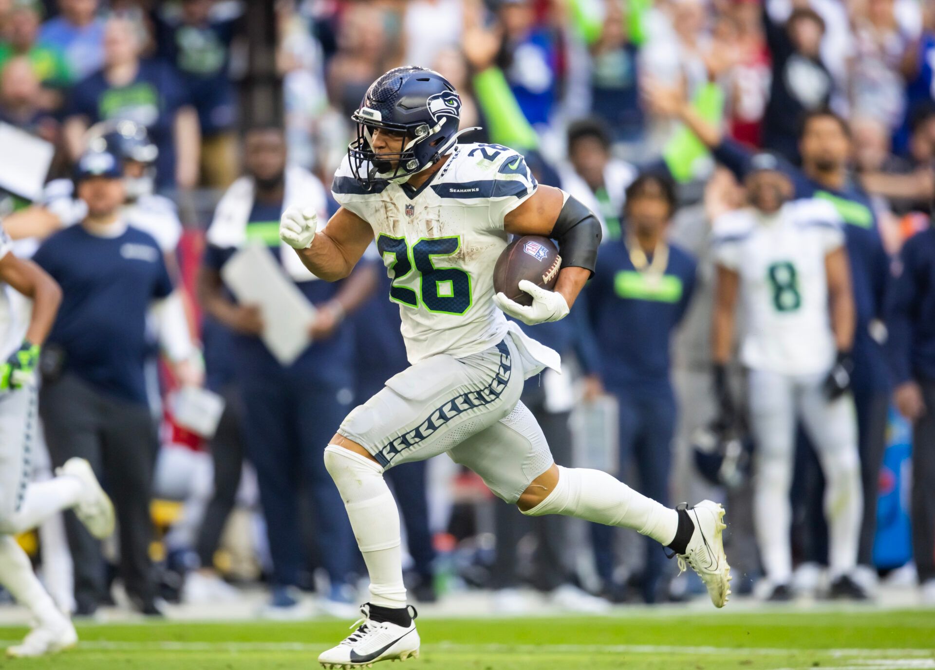 Seattle Seahawks running back Zach Charbonnet (26) runs for a touchdown against the Arizona Cardinals in the first half at State Farm Stadium.