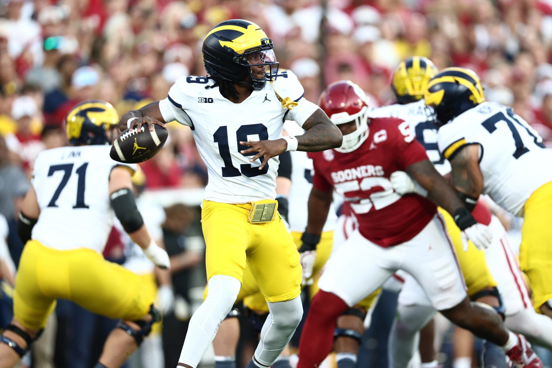 Michigan Wolverines quarterback Bryce Underwood (19) looks to pass downfield against the Oklahoma Sooners during the first half at Gaylord Family-Oklahoma Memorial Stadium.