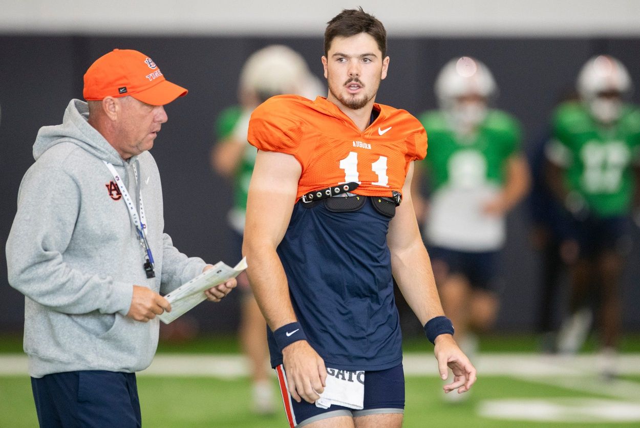 Auburn Tigers head coach Hugh Freeze talks with quarterback Jackson Arnold (11) during practice at Woltosz Football Performance Center in Auburn, Ala. on Tuesday, Aug. 26, 2025.