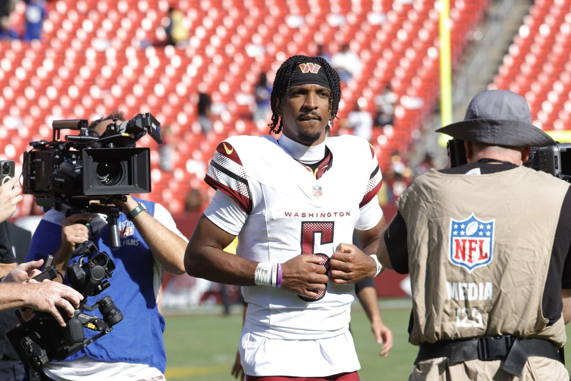 Washington Commanders quarterback Jayden Daniels (5) walks off the field after the game against the New York Giants at Northwest Stadium.