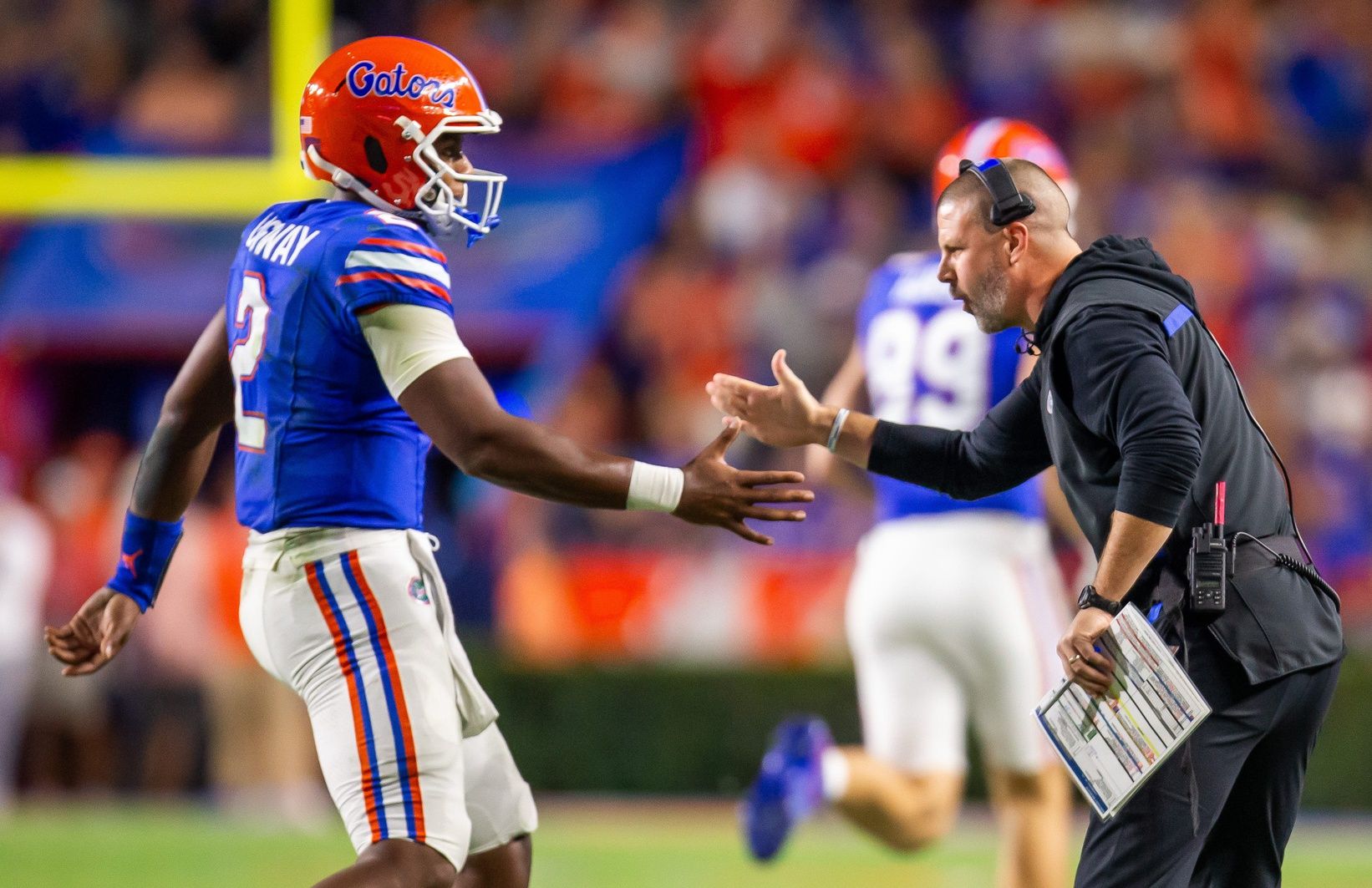 Florida Gators quarterback DJ Lagway (2) is congratulated by Florida Gators head coach Billy Napier after a series during the first half at Ben Hill Griffin Stadium in Gainesville, FL on Saturday, October 19, 2024 against the Kentucky Wildcats. [Doug Engle/Gainesville Sun]