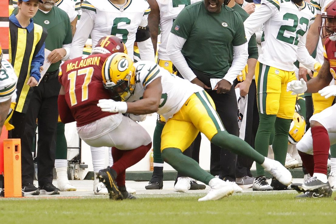 Washington Commanders wide receiver Terry McLaurin (17) is tackled by Green Bay Packers safety Rudy Ford (20) after catching a pass to convert a third down late in the fourth quarter at FedExField.