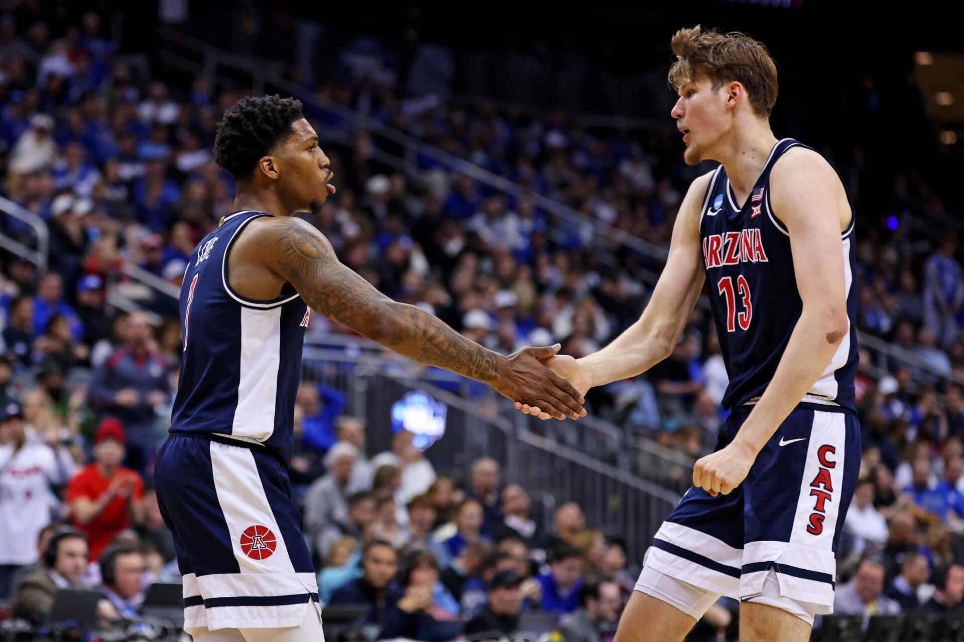 Arizona Wildcats guard Caleb Love (1) and forward Henri Veesaar (13) celebrates during the first half against the Duke Blue Devils during an East Regional semifinal of the 2025 NCAA tournament at Prudential Center.