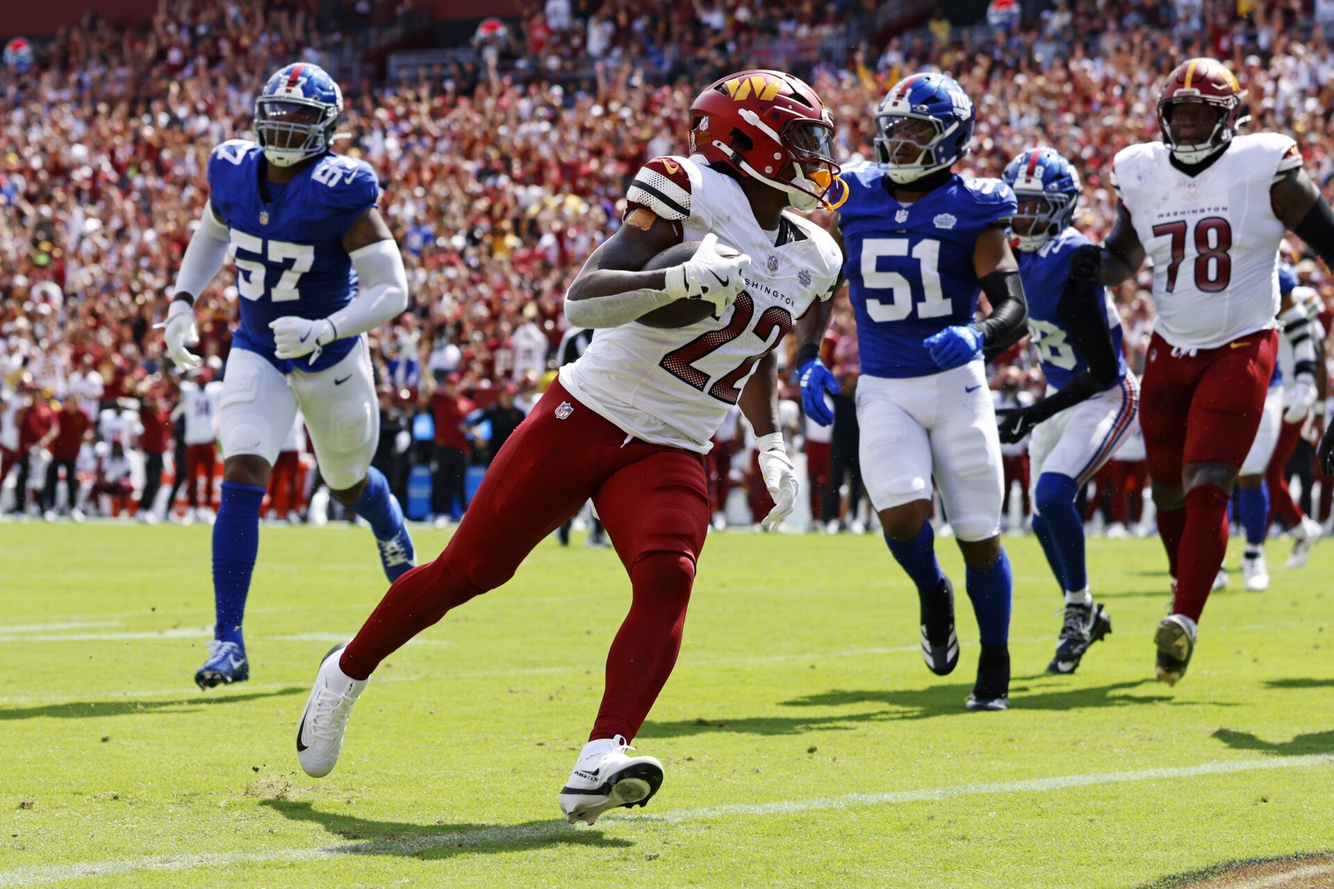 Washington Commanders running back Jacory Croskey-Merritt (22) scores a touchdown during the second quarter against the New York Giants at Northwest Stadium.