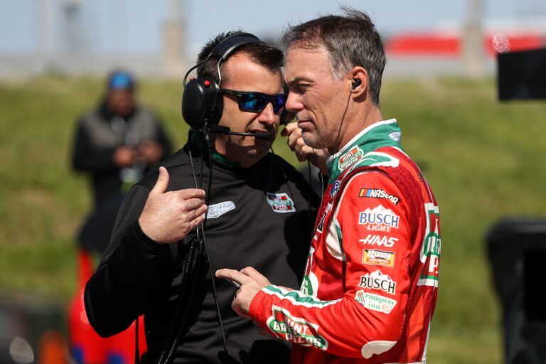 NASCAR Cup Series driver Kevin Harvick (right) talks with his crew chief Rodney Childers (left) during practice for the DuraMAX Drydene 400 at Dover Motor Speedway.