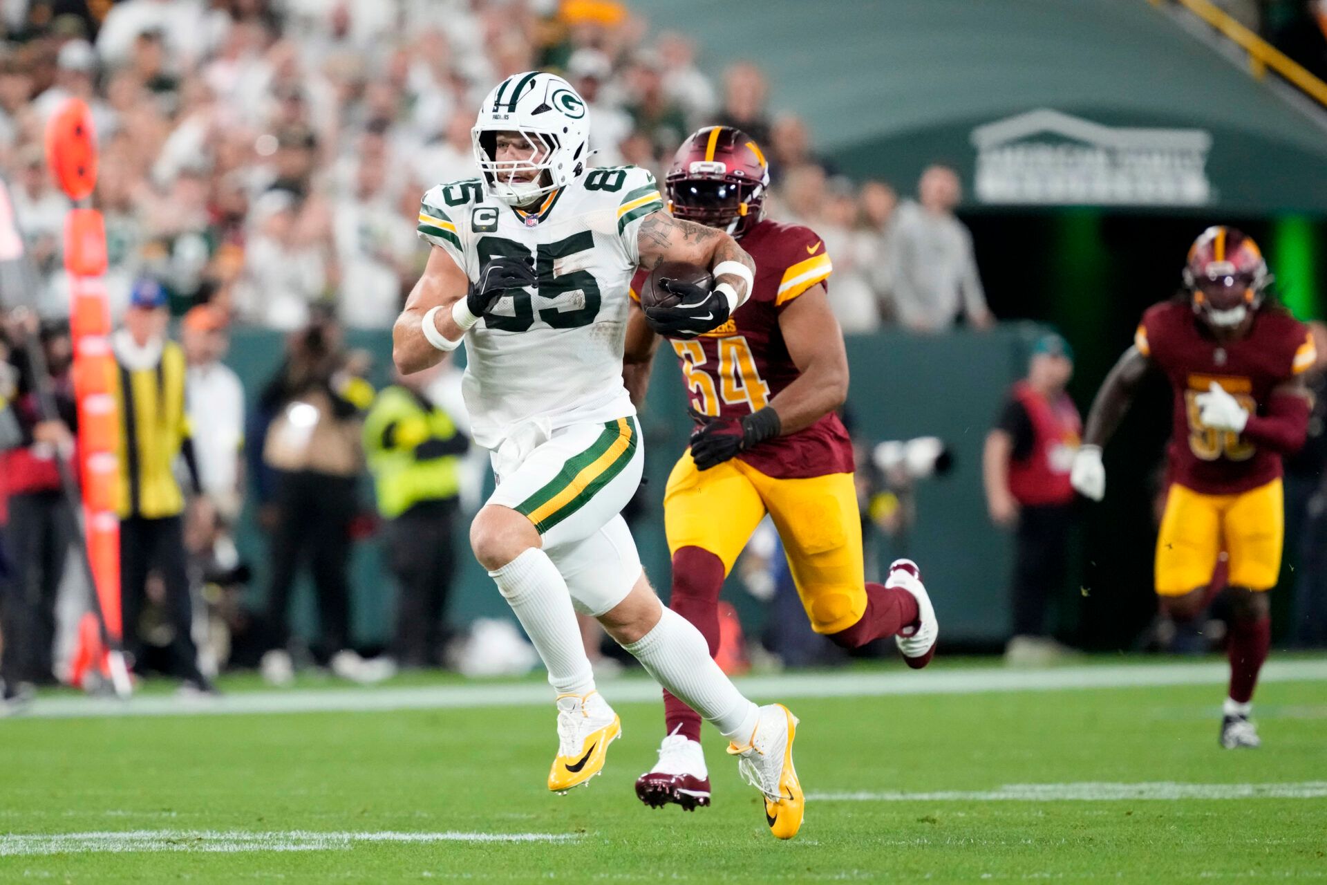 Green Bay Packers tight end Tucker Kraft (85) runs against the Washington Commanders in the first quarter at Lambeau Field.