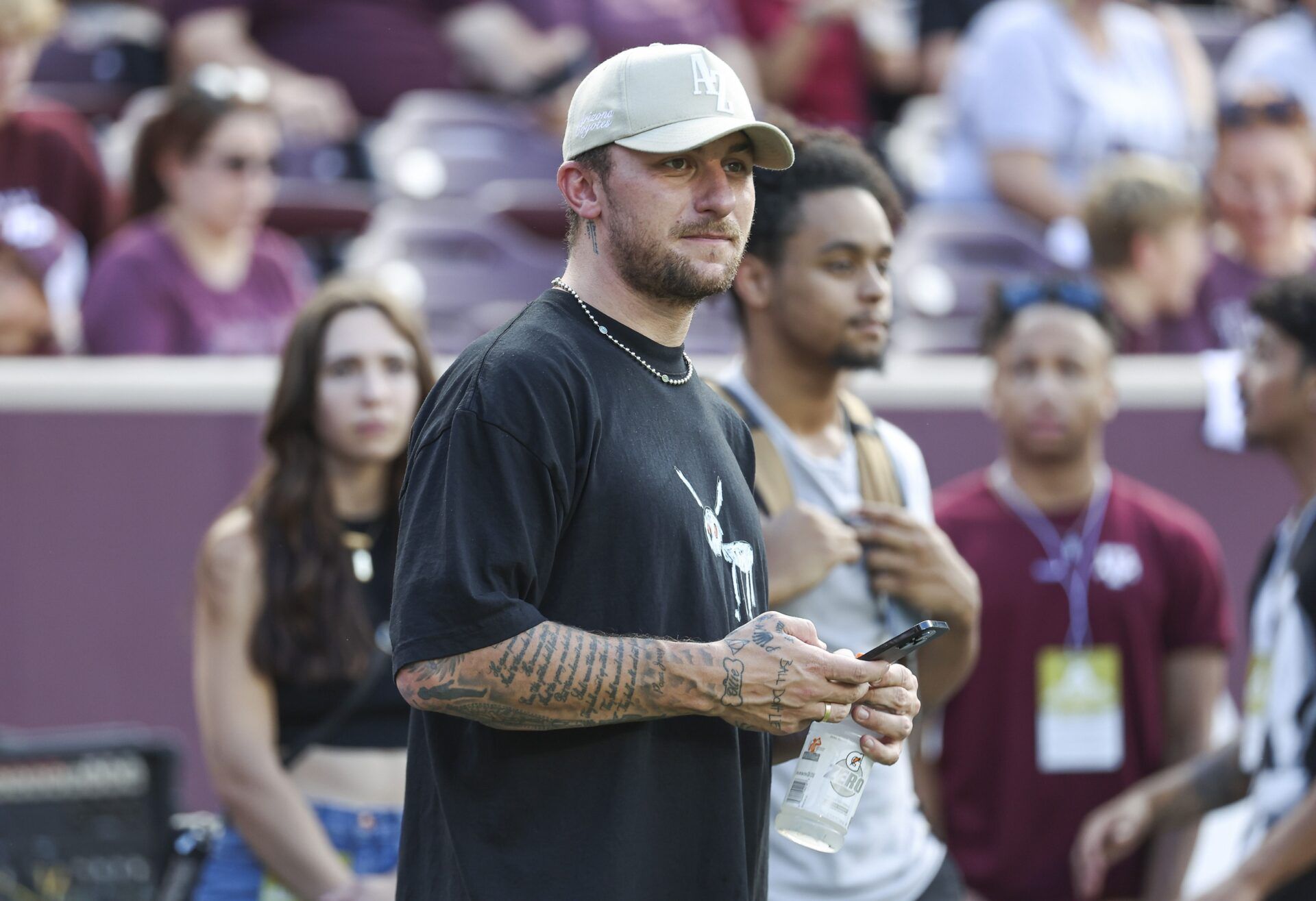 Former Texas A&M Aggies player Johnny Manziel watches from the sideline during the first half of the game between the Aggies and the Louisiana Monroe Warhawks at Kyle Field.