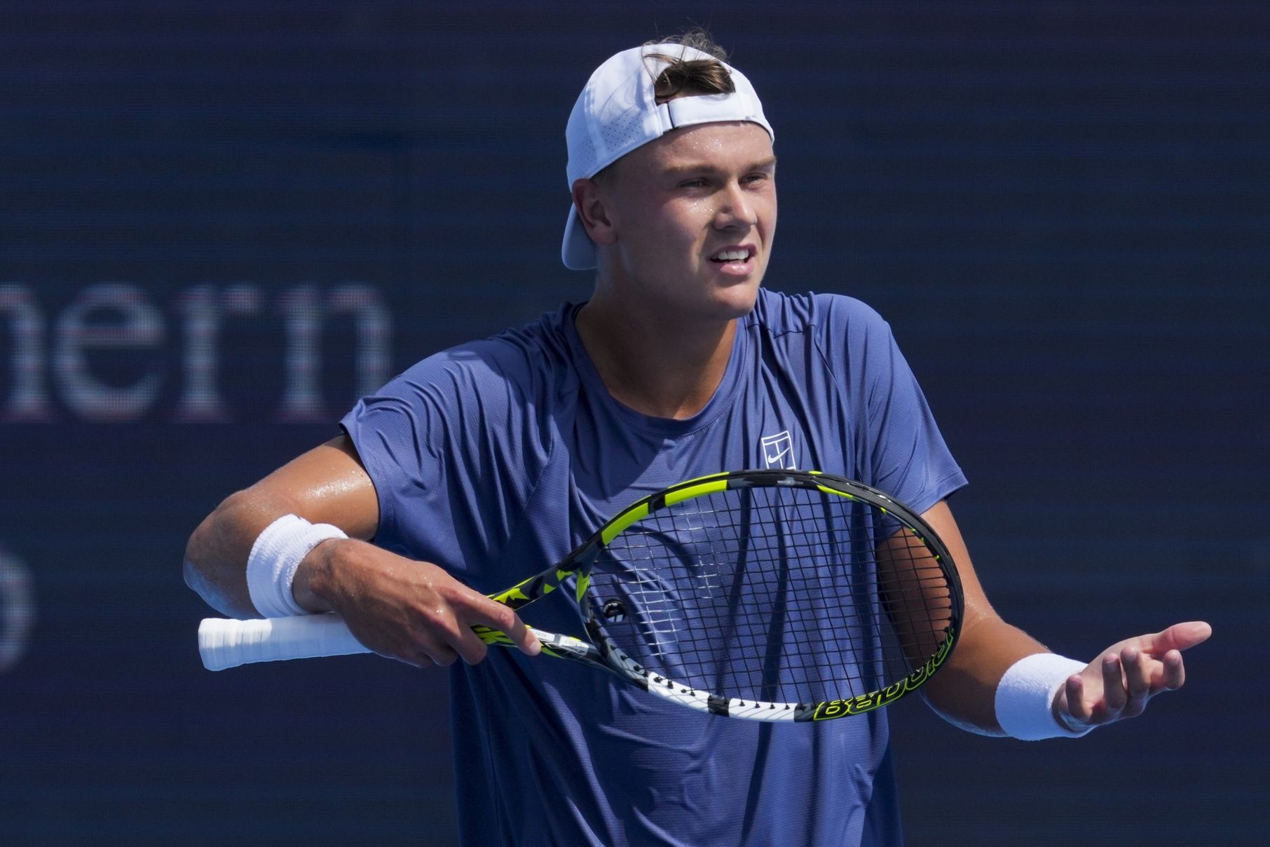 Holger Rune (DEN) reacts after returning a shot against Frances Tiafoe (USA) during the Cincinnati Open at the Lindner Family Tennis Center.