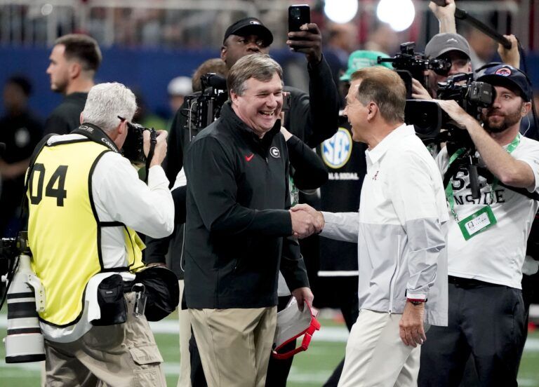 Georgia Bulldogs head coach Kirby Smart and Alabama Crimson Tide head coach Nick Saban meet before the SEC Championship Game at Mercedes-Benz Stadium.