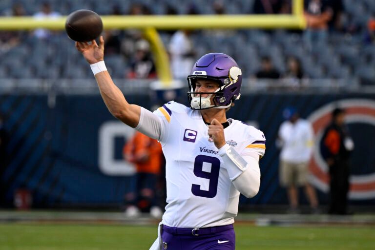 Minnesota Vikings quarterback J.J. McCarthy (9) practices before the game at Soldier Field.