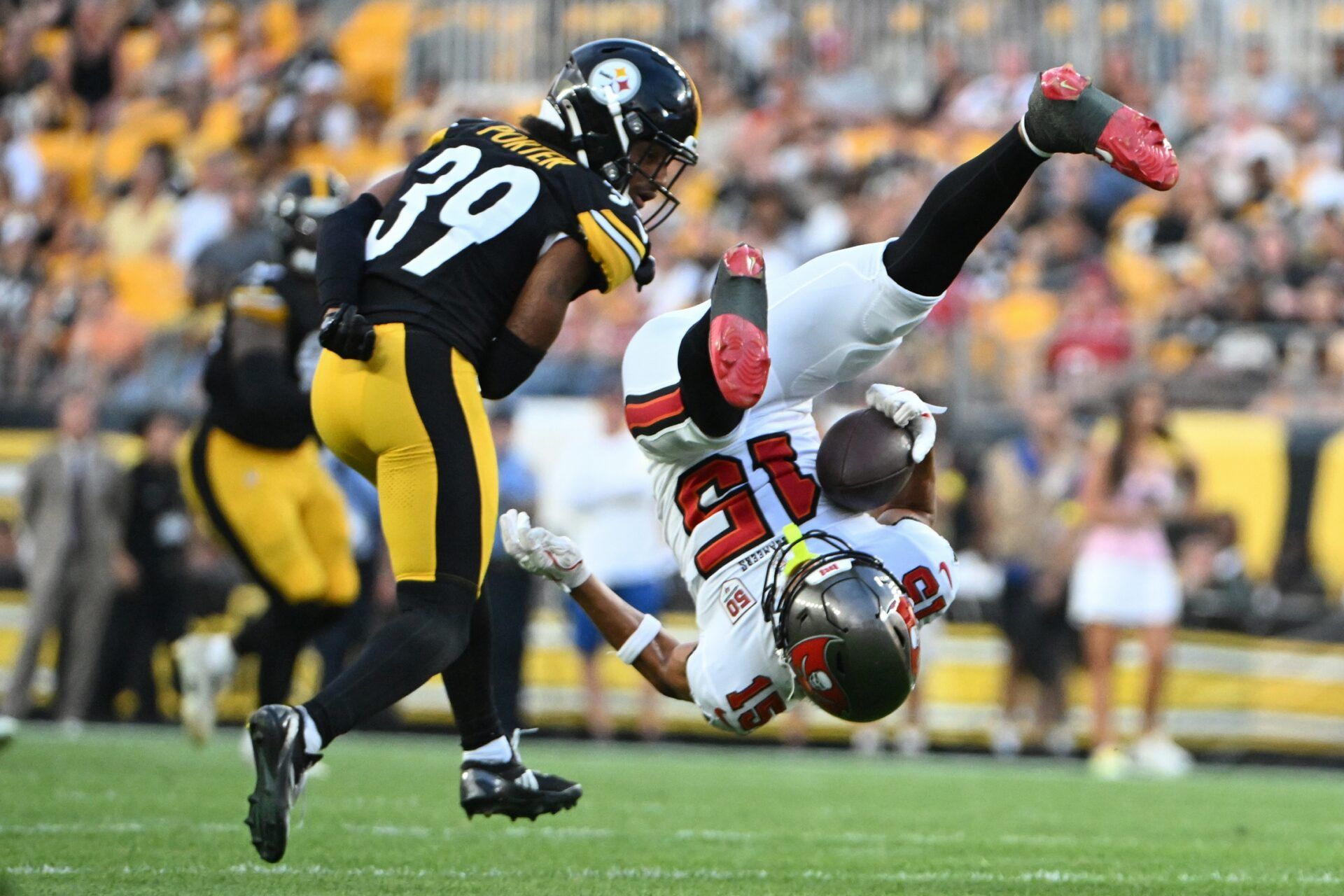 Tampa Bay Buccaneers wide receiver Jalen McMillan (15) makes a catch against Pittsburgh Steelers cornerback Daryl Porter Jr. (39) during the first quarter at Acrisure Stadium.