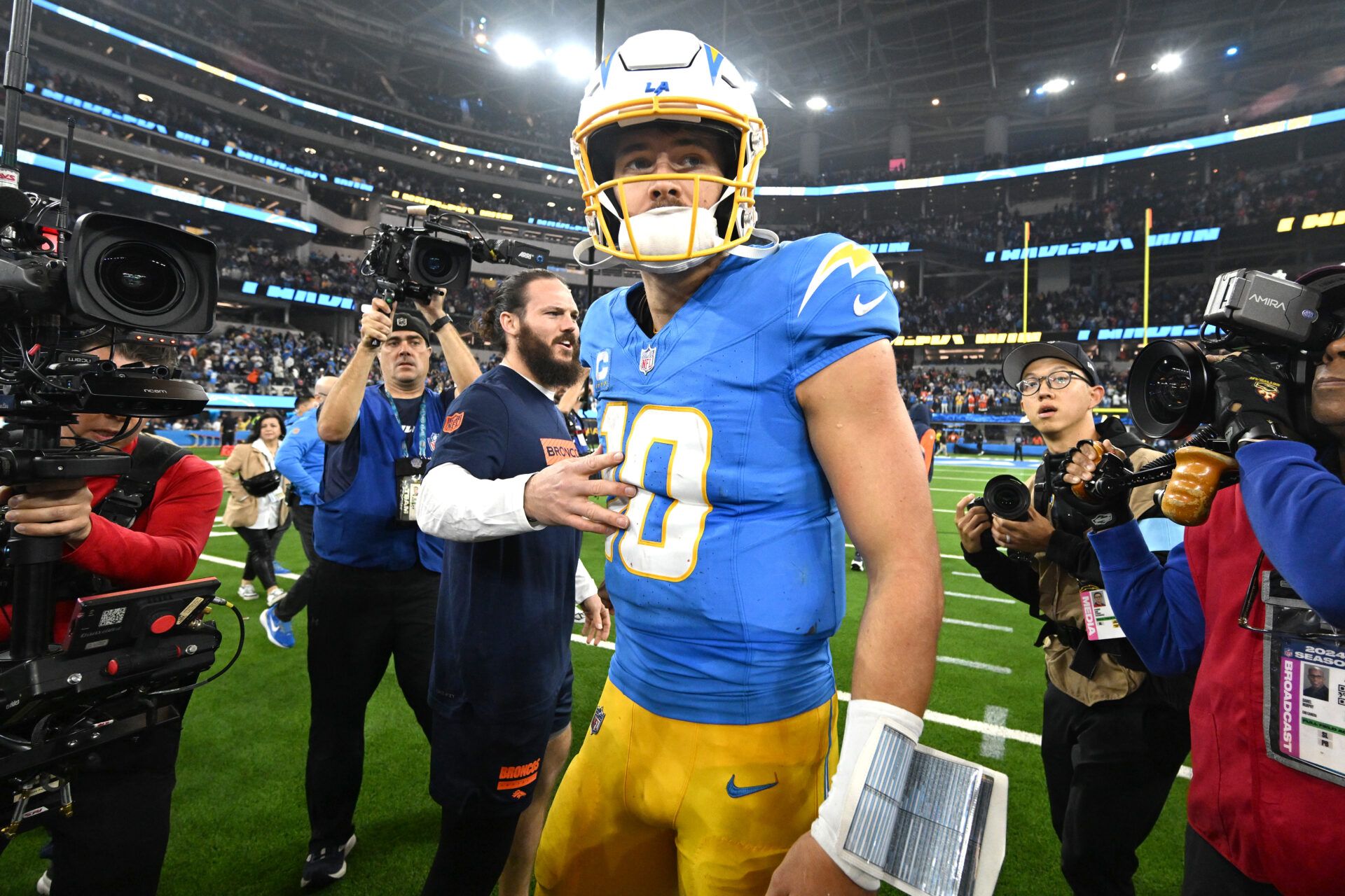 Los Angeles Chargers quarterback Justin Herbert (10) celebrates as he leaves the field after defeating the Denver Broncos at SoFi Stadium.