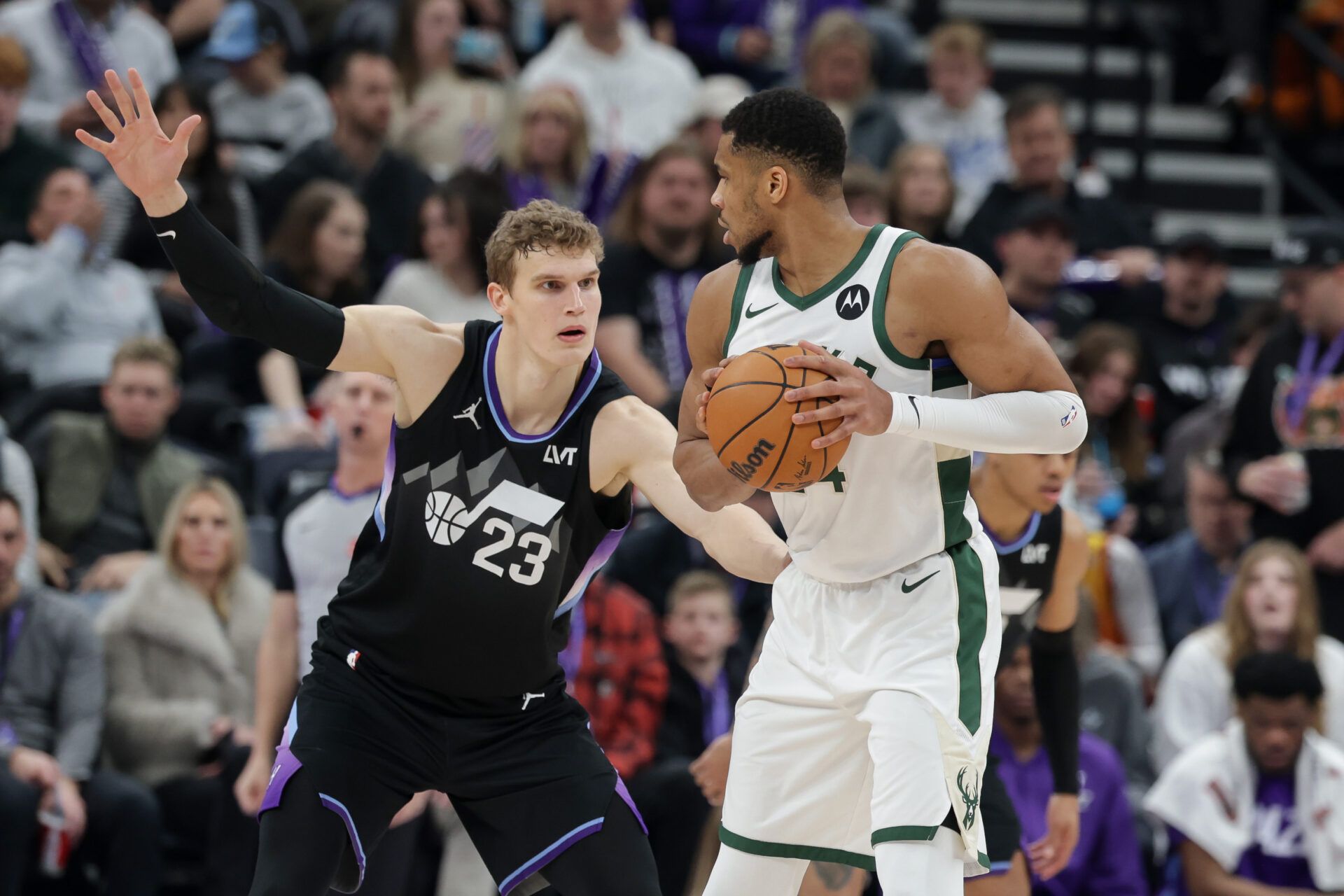 Milwaukee Bucks forward Giannis Antetokounmpo (34) keeps the ball away from Utah Jazz forward Lauri Markkanen (23) during the second half at Delta Center.