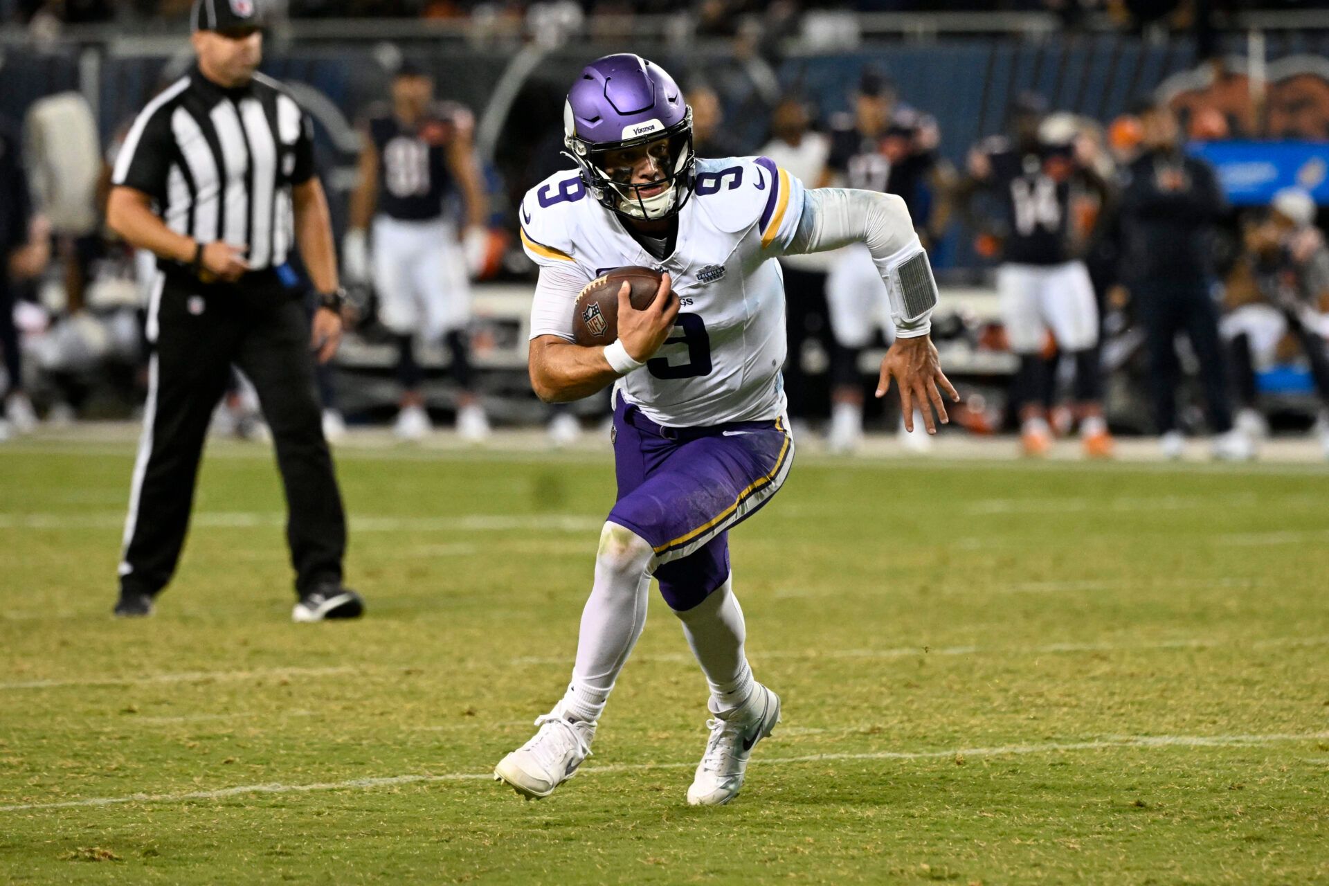 Minnesota Vikings quarterback J.J. McCarthy (9) rushes the ball against the Chicago Bears during the second half at Soldier Field.