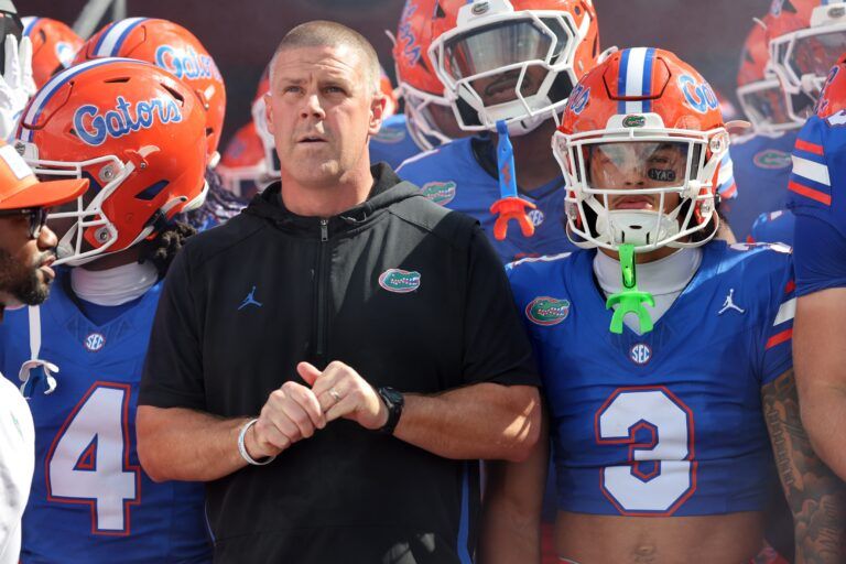 Florida Gators head coach Billy Napier and teammates run out of the tunnel prior to the game against the South Florida Bulls at Ben Hill Griffin Stadium.