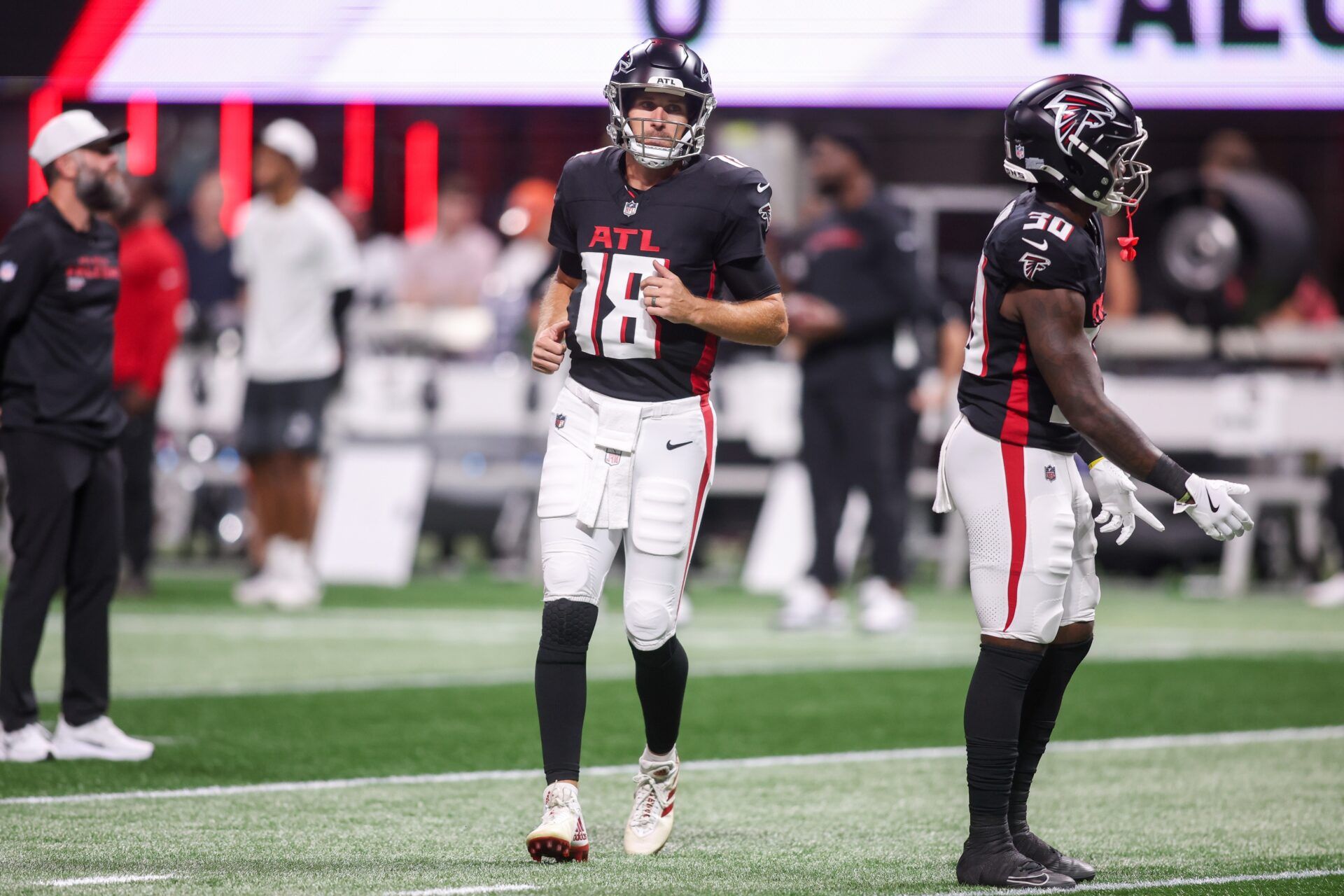 Atlanta Falcons quarterback Kirk Cousins (18) warms up before a game against the Tennessee Titans at Mercedes-Benz Stadium.