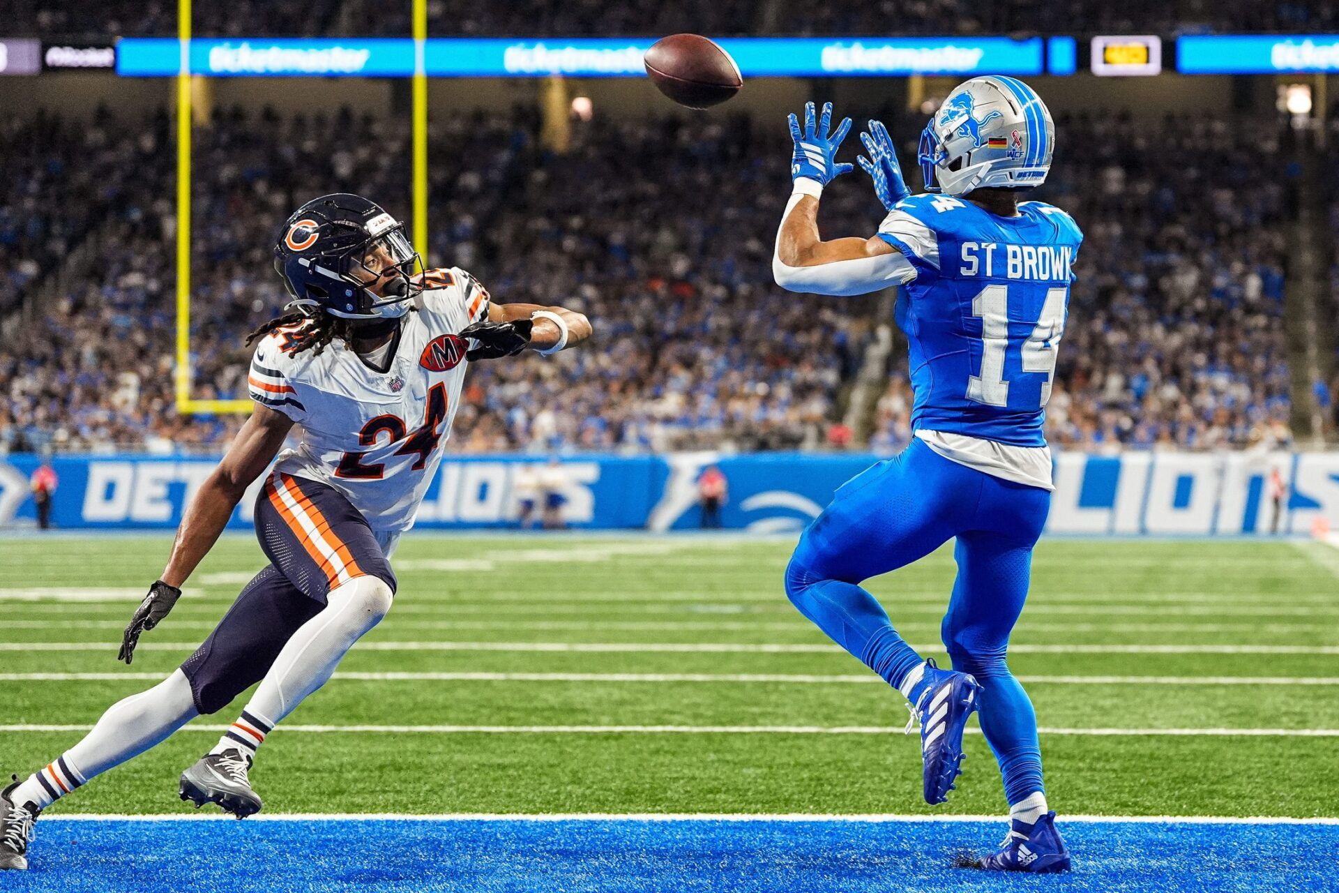 Detroit Lions wide receiver Amon-Ra St. Brown (14) makes a catch for a touchdown against Chicago Bears cornerback Nick McCloud (24) during the second half at Ford Field in Detroit on Sunday, Sept. 14, 2025.