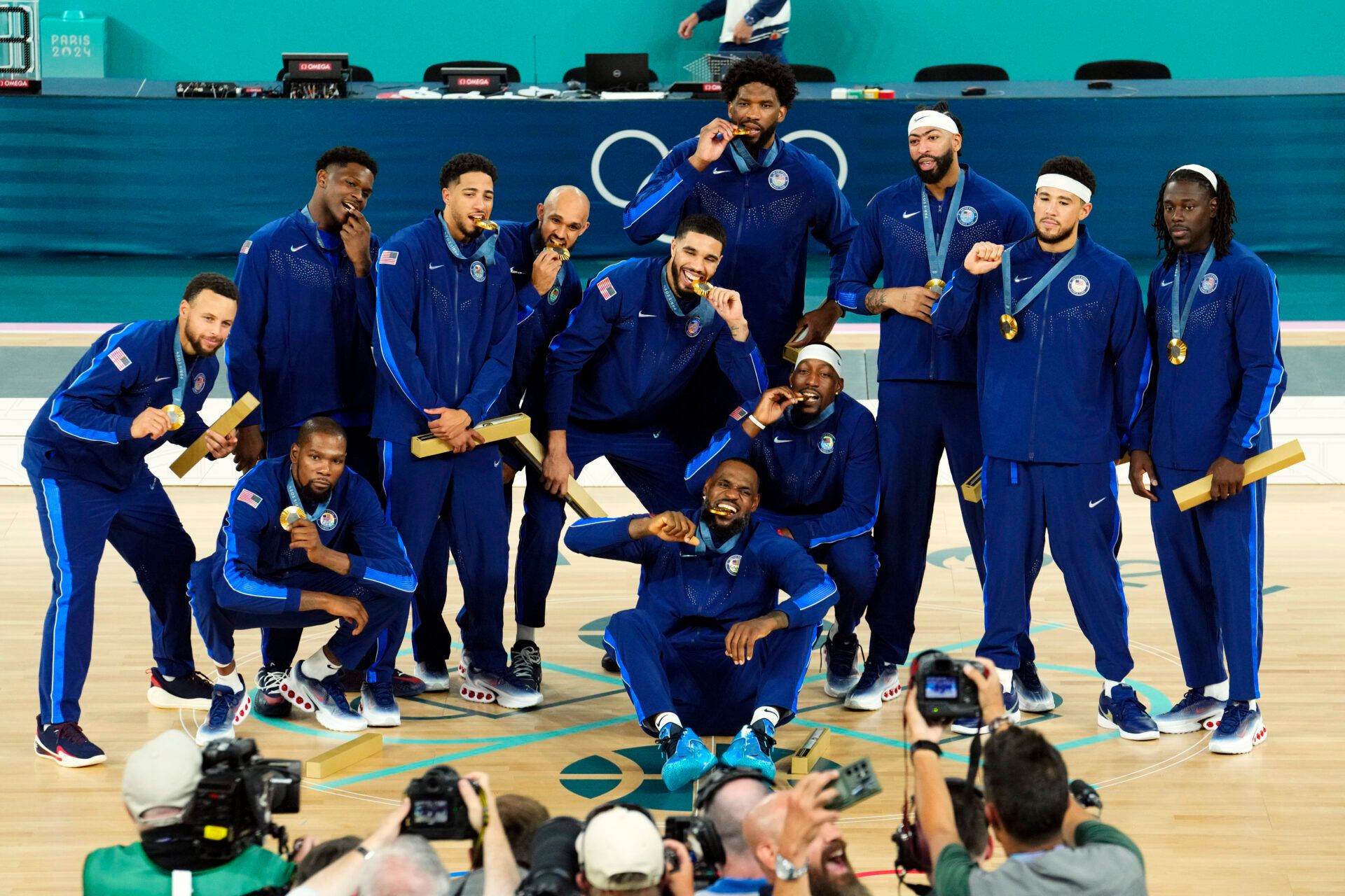 Team USA pose for a photo after defeating France in the men's basketball gold medal game during the Paris 2024 Olympic Summer Games at Accor Arena.