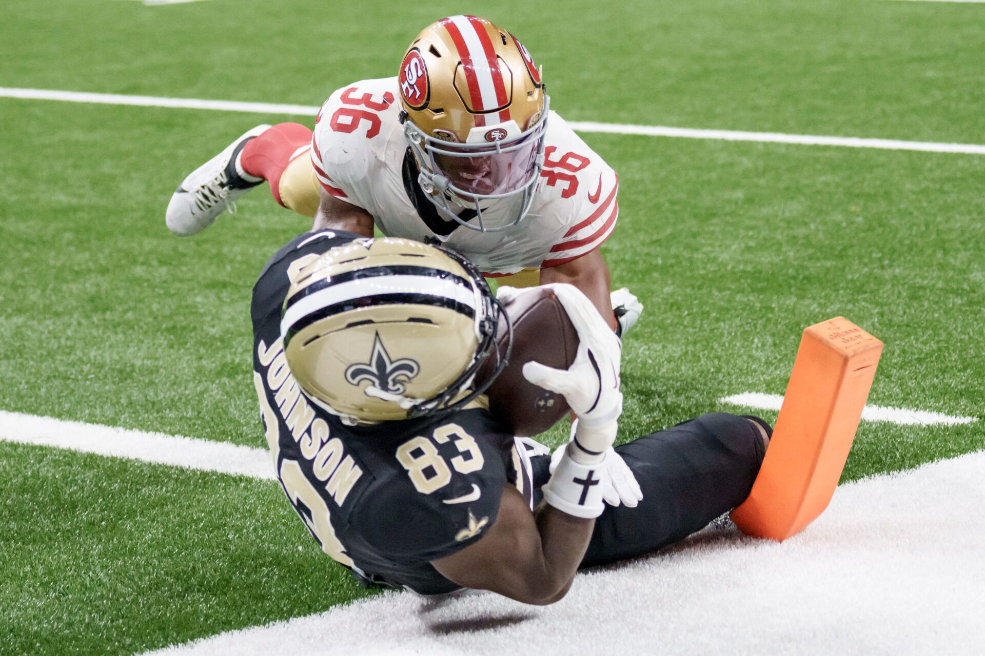 New Orleans Saints tight end Juwan Johnson (83) catches  a touchdown against San Francisco 49ers safety Marques Sigle (36) during the second quarter at Caesars Superdome.