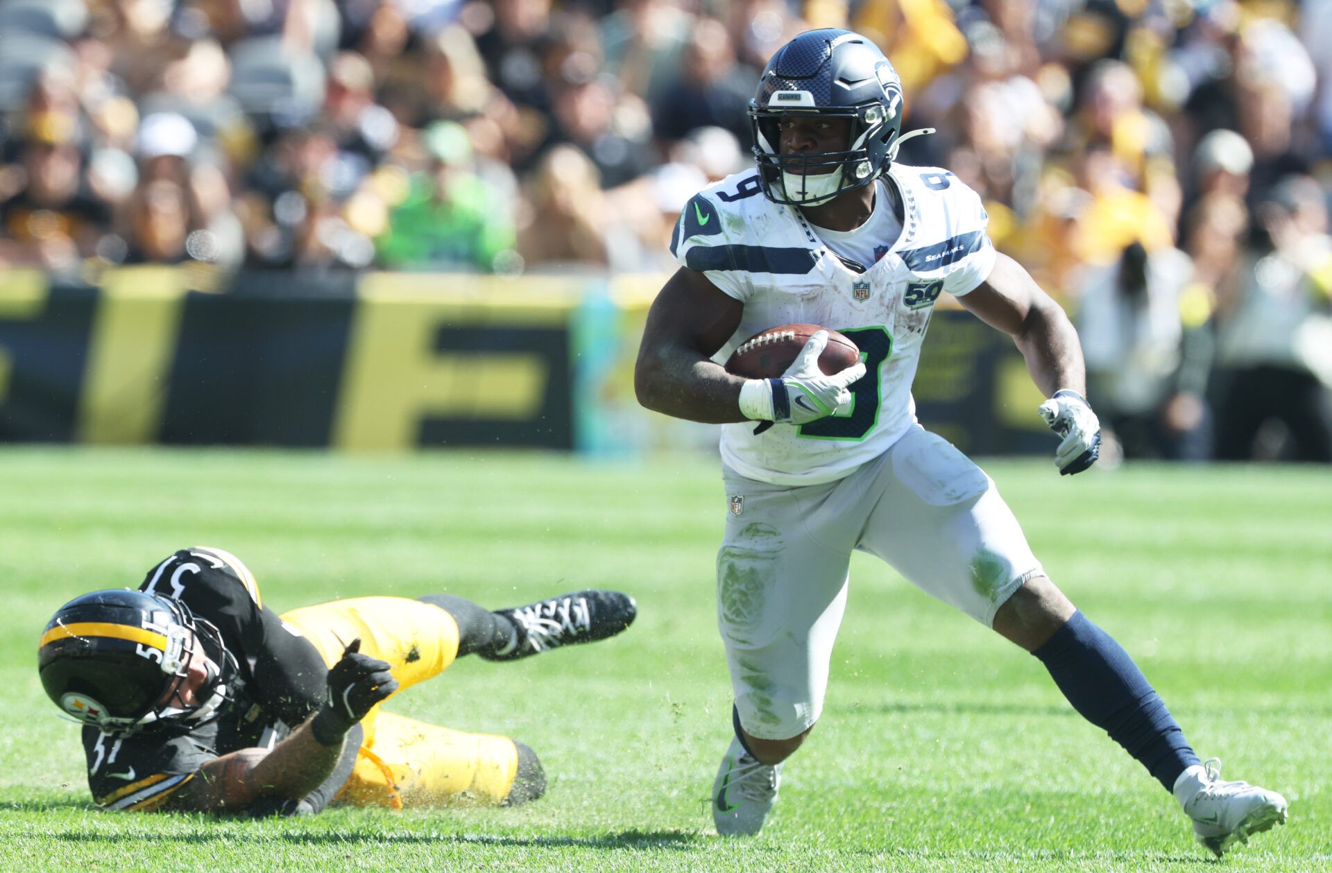 Seattle Seahawks running back Kenneth Walker III (9) runs the ball past Pittsburgh Steelers linebacker Nick Herbig (51) during the fourth quarter at Acrisure Stadium.