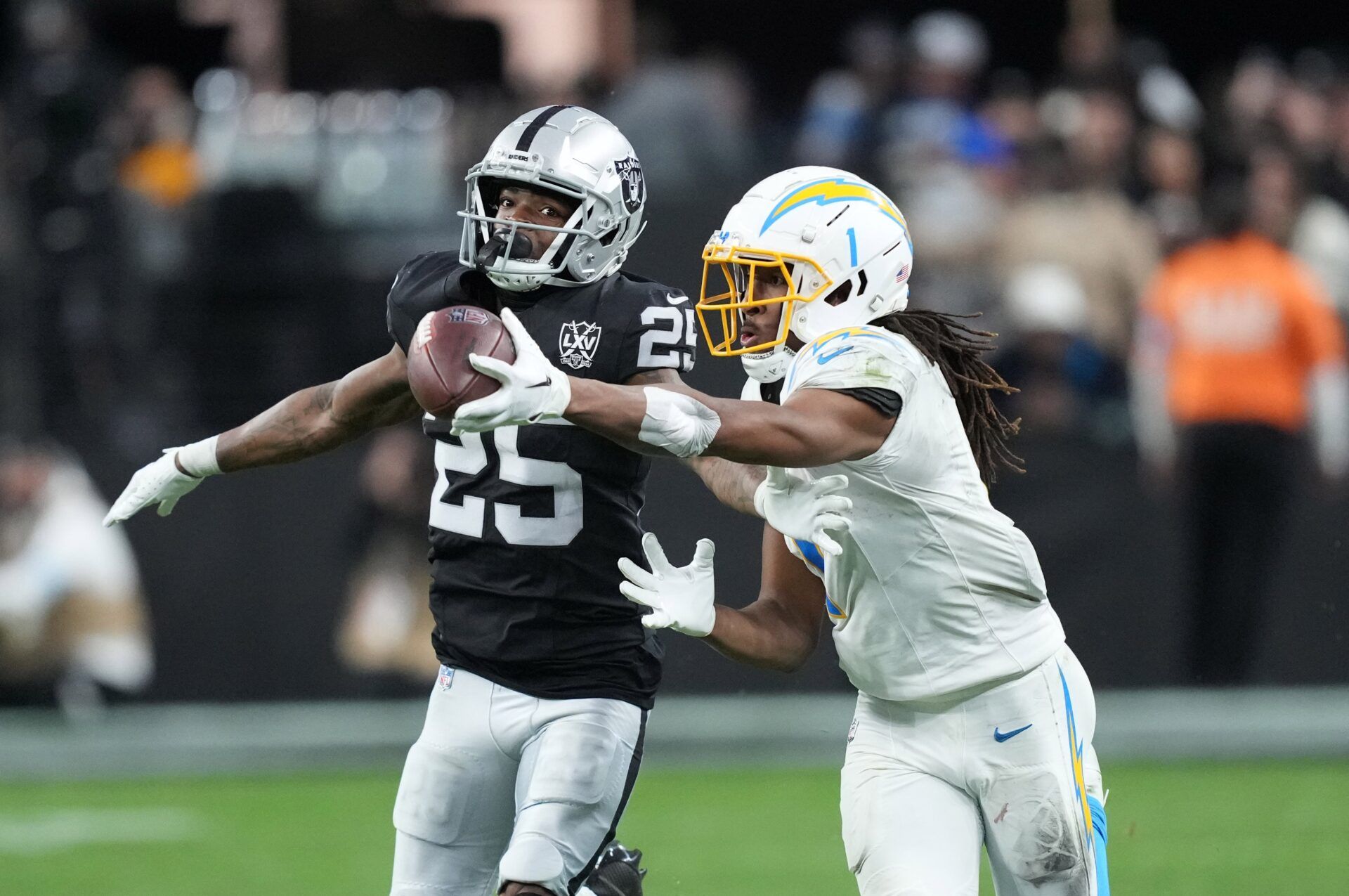 Los Angeles Chargers wide receiver Quentin Johnston (1) catches the ball against Las Vegas Raiders cornerback Decamerion Richardson (25) at Allegiant Stadium.